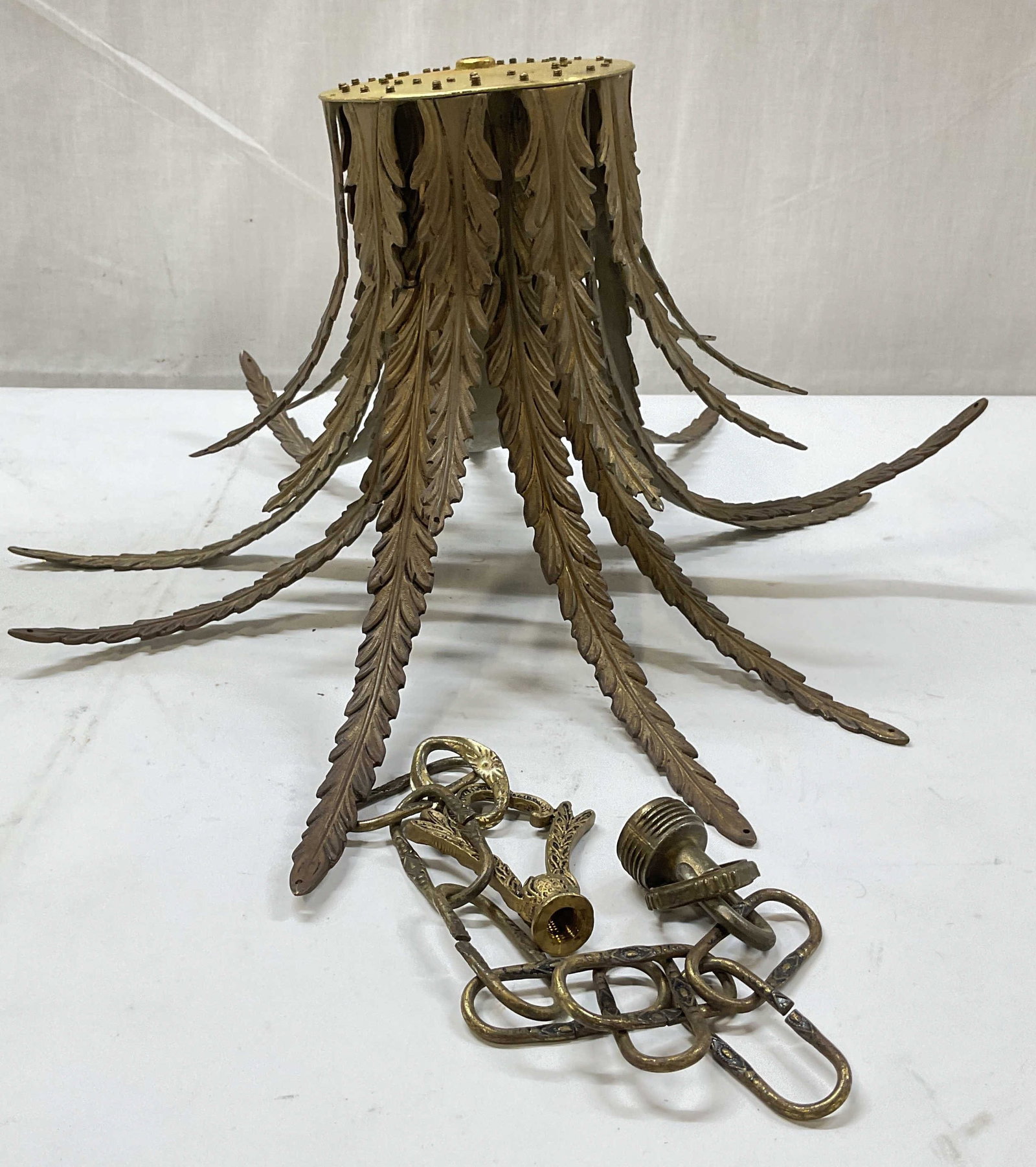 Vintage Brass Acanthus Chandelier Finial: Vintage brass acanthus leaf motif chandelier finial. Measures approx. 8.25 x 8 inches. Includes a chain. Wear including scratching, patina, warping. Chandelier finial, light fixture, home decor, home 