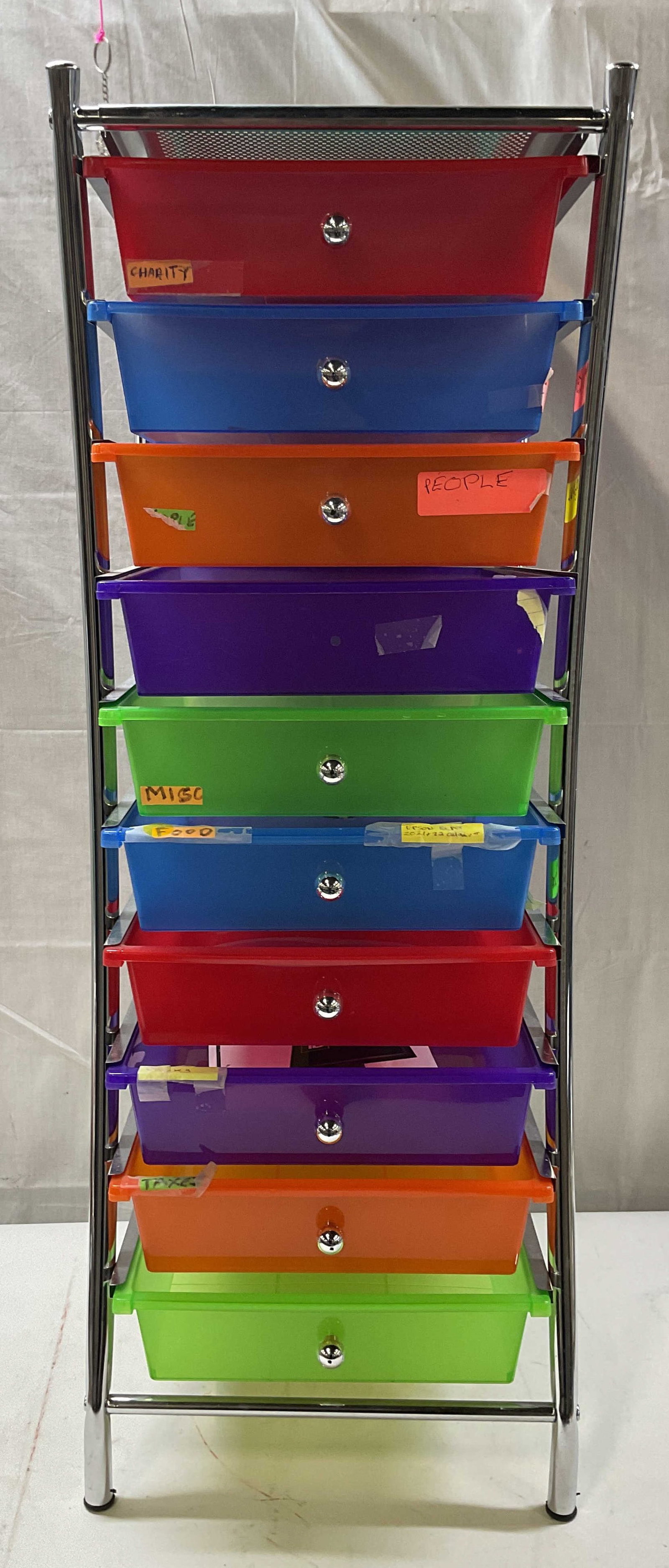 Colorful 10 Drawer Storage Tower: Colorful 10 drawer storage tower. Metal and plastic. Measures approx. 15.5 x 13 x 35.75 inches. Label residue, scratching, one handle needs replacement. Storage tower, storage, home decor, home