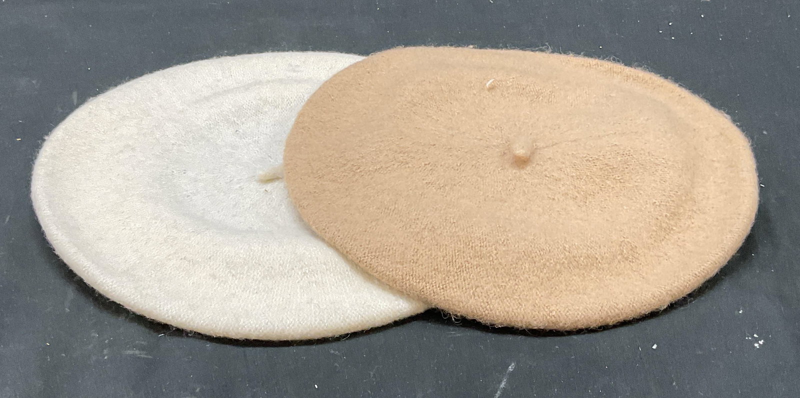 Lot 2 Tan & White Wool Beret Hats: Lot of 2 wool berets in tan and white. Measures approx. 6 inches wide at opening. Some wear including pilling and rubbing. Beret, wool berets, wool hat, accessories, fashion accessories, wearables,
