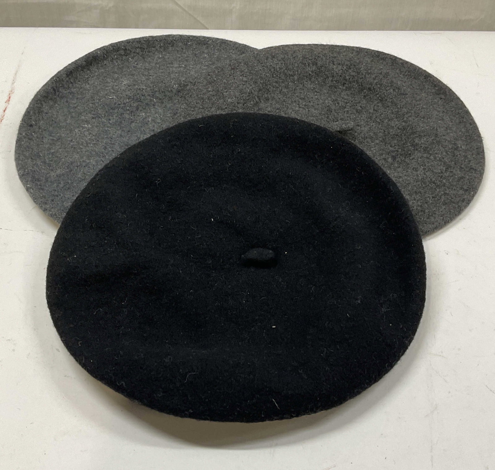 Lot 3 Black & Grey Wool Beret Hats: Lot of 2 wool berets in grey and black. Measures approx. 6 inches wide at opening. Some wear including pilling and rubbing. Beret, wool berets, wool hat, accessories, fashion accessories, wearables,