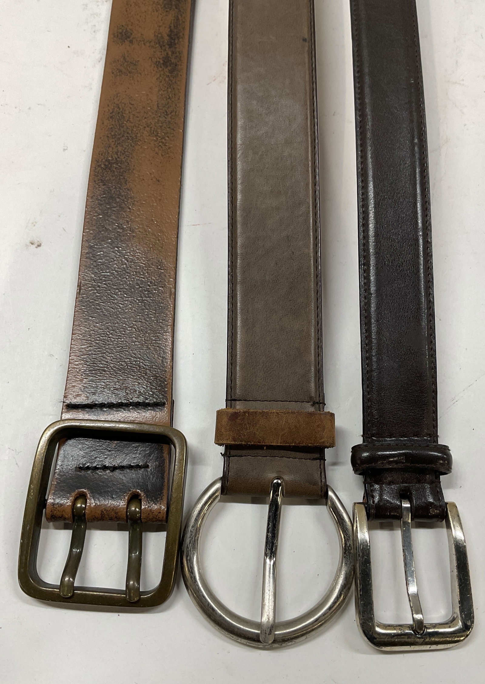 Lot 3 Levis + Brown Leather Belts: Lot of 3 brown leather belts. Levis belt, size 36. 2 leather belts, one size 32. some wear to hardware and leather including scratching, cracking, and rubbing. Belt, leather belt, accessories,