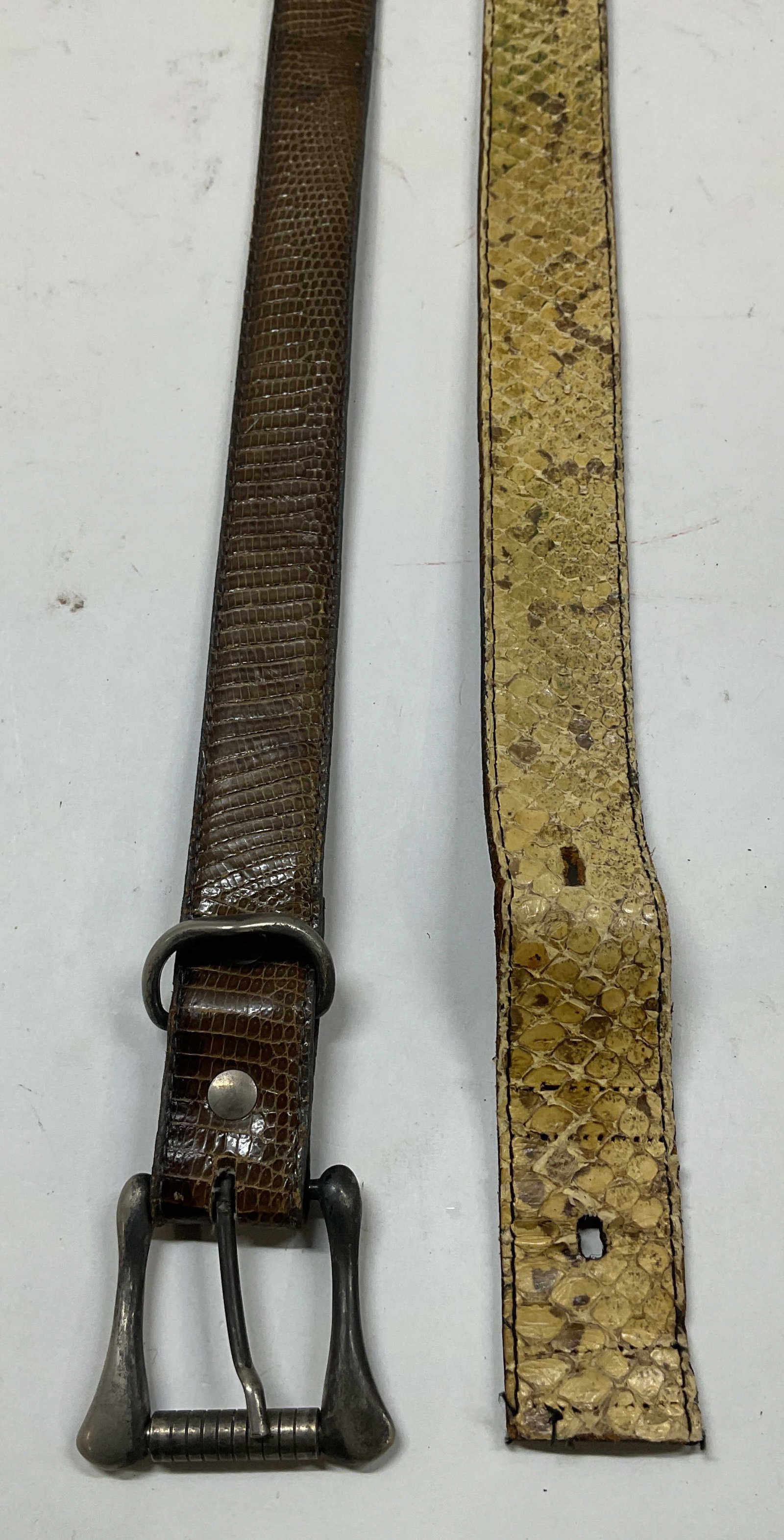 Lot 2 Lizard & Snakeskin Leather Belts: Lot of 2 lizard and snakeskin leather belts in brown and yellow. Largest measures approx. 37.5 inches long. some wear to hardware and leather including scratching, cracking and rubbing. Belt, leather