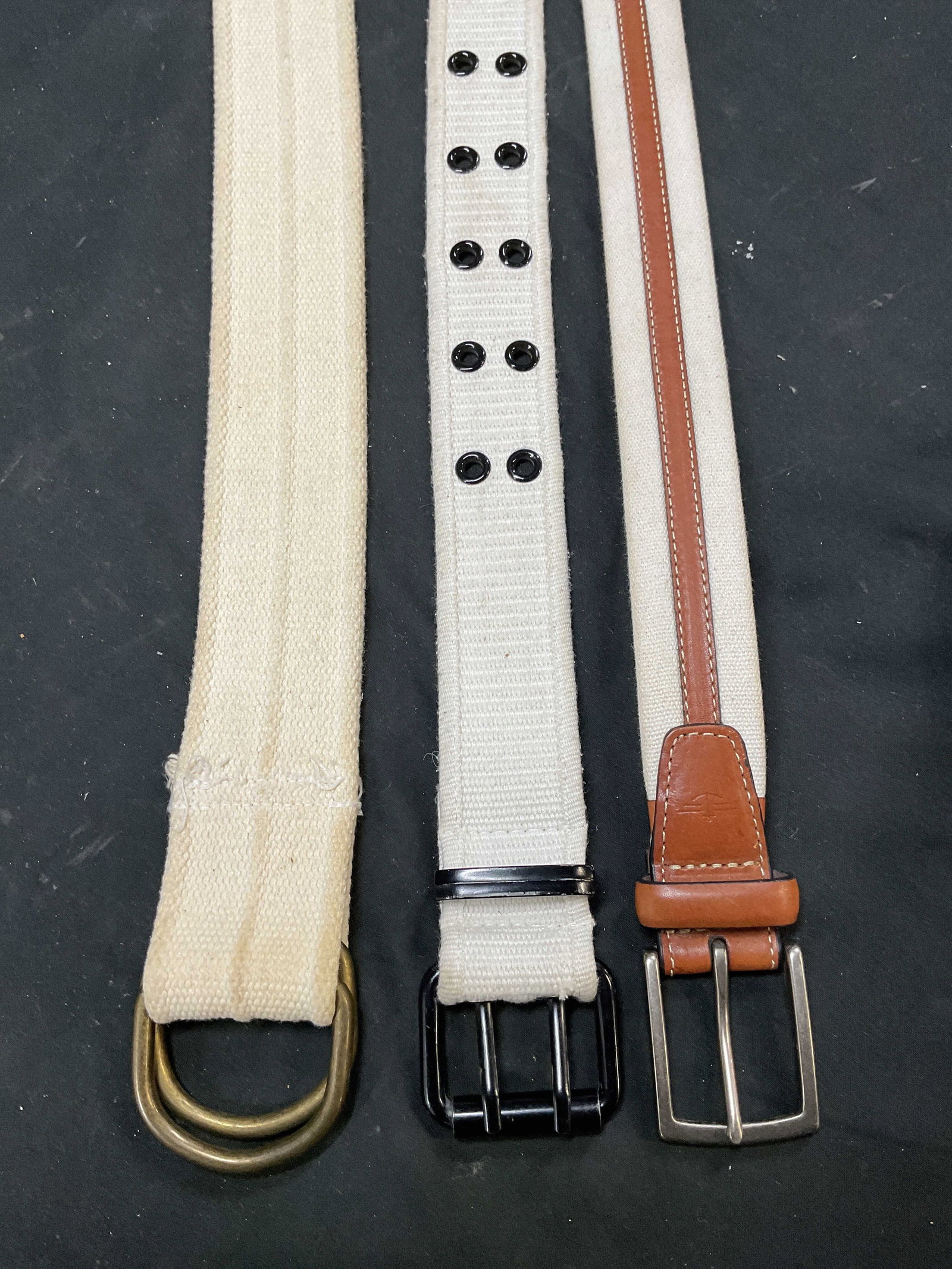 Lot 3 White Fabric & Leather Belts: Lot of 3 white fabric belts. One with leather accent. Sizes marked 30 and small. Largest measures approx. 41.5 inches. some wear to hardware and fabric including blemishes and rubbing. Belt, fabric