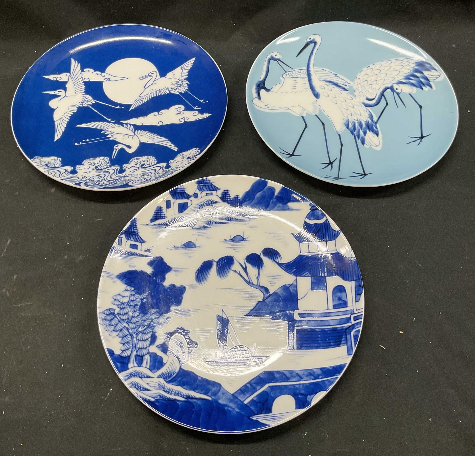 Set 3 The Met Blue & White Porcelain Plates: Set of 3 The Metropolitan Museum of Art blue and white Asian bird and landscape porcelain plates. Hand painted. Measures approx. 8 inches wide. Some scratching. The met plates, blue and white plates, 