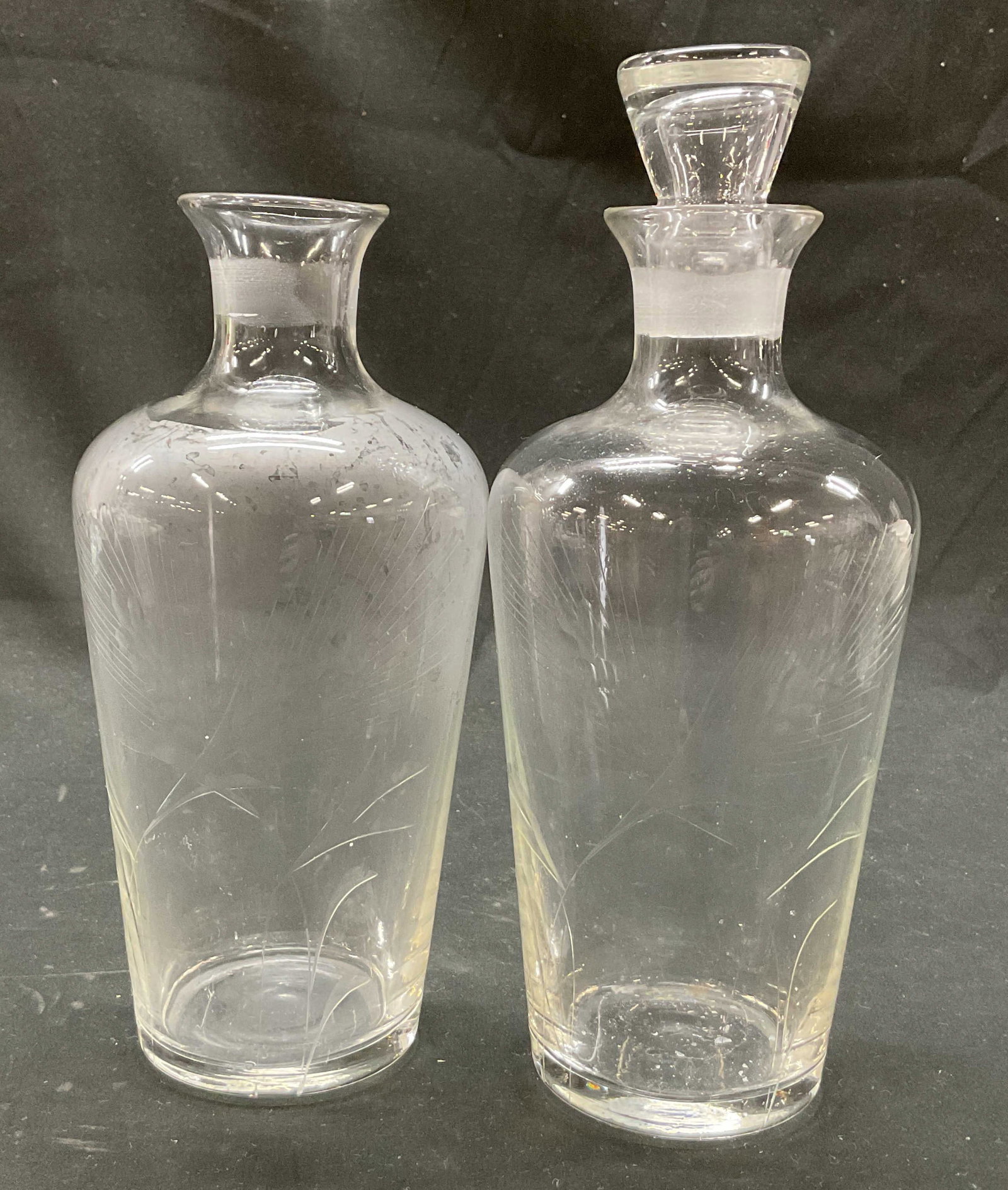 Pair Vintage Etched Glass Decanter W Stopper: Pair of vintage etched glass decanters. One has a stopper. Bulbous body. Etched floral and leaf motifs. Measures ht approx 9.5 inches base diam approx 2.5 inches. Stopper has chipping. Decanter, table