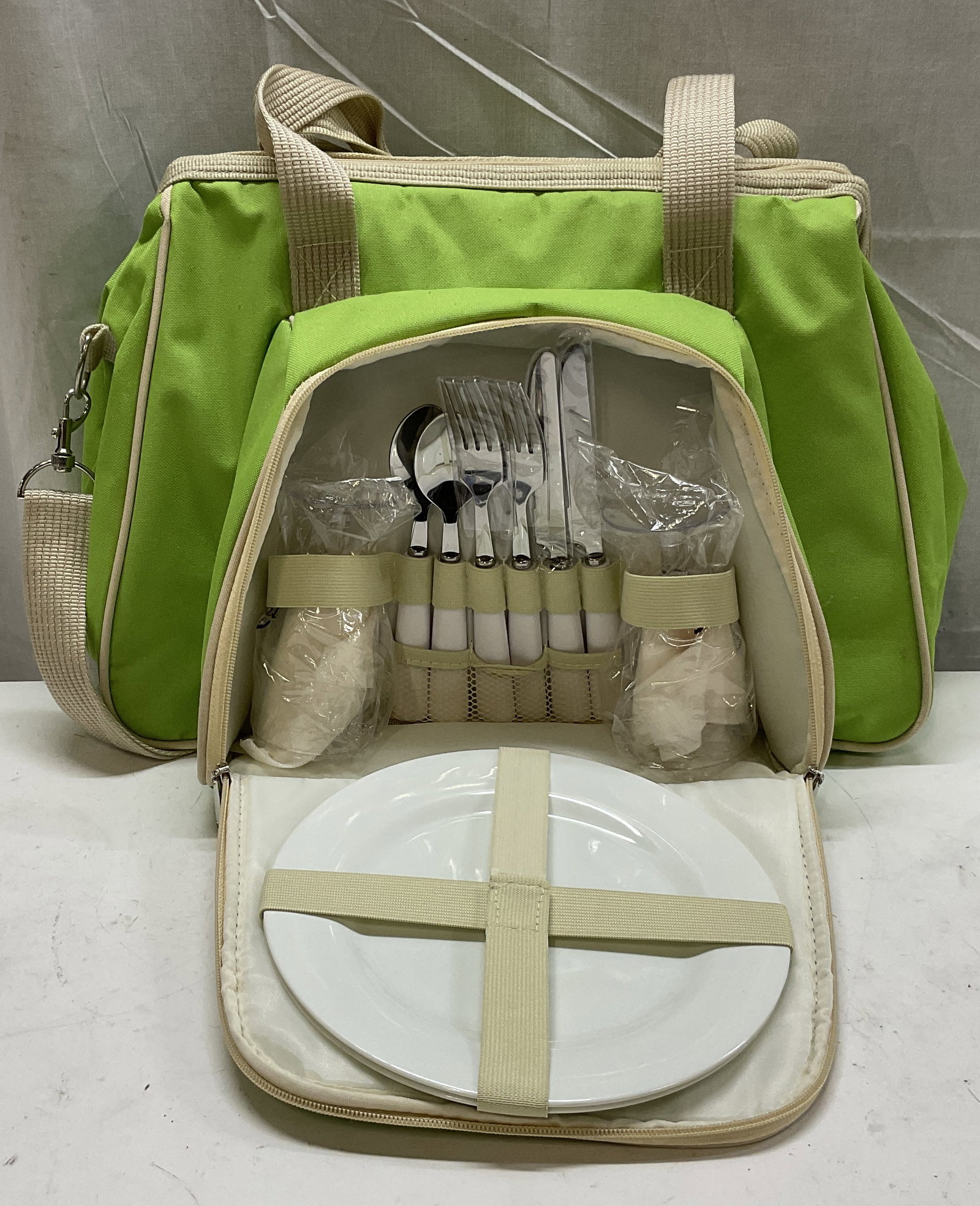 Neon Green & Beige Insulated Canvas Picnic Bag: Neon Green & Beige Insulated Canvas Picnic Bag. Larger Section is a Cooler. Contains 2 Plastic Plates, 2 Plastic Wine Glasses, 2 Cloth Napkins, 2 Forks, Two Spoons, and 2 Serated Knives. Measures app 
