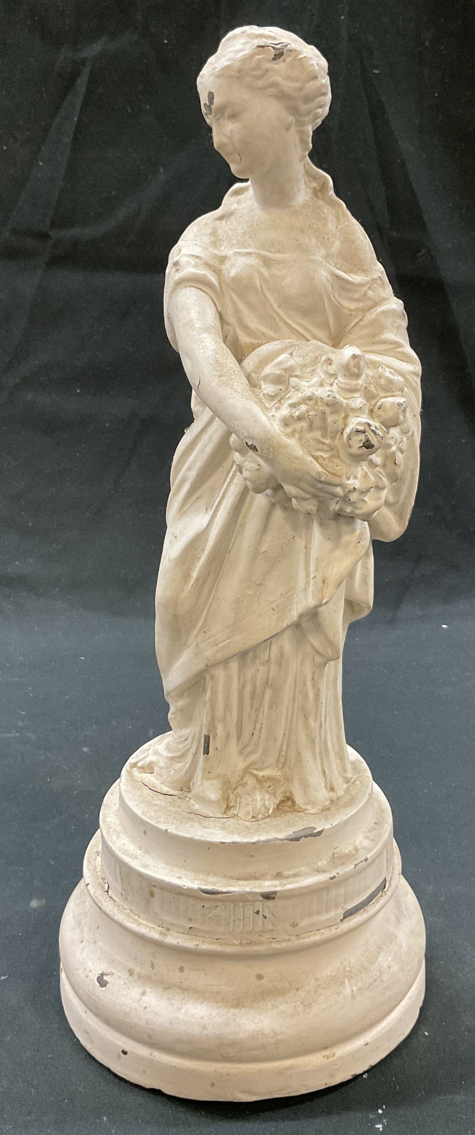 Vtg Neoclassical Style Enameled Metal Statue: Vintage Neoclassical style enameled metal statue. Round wooden pedestal base. Neoclassical style figure. Appears to be a woman figure. Holding a basket of what could be fruit or flowers. Classical dre
