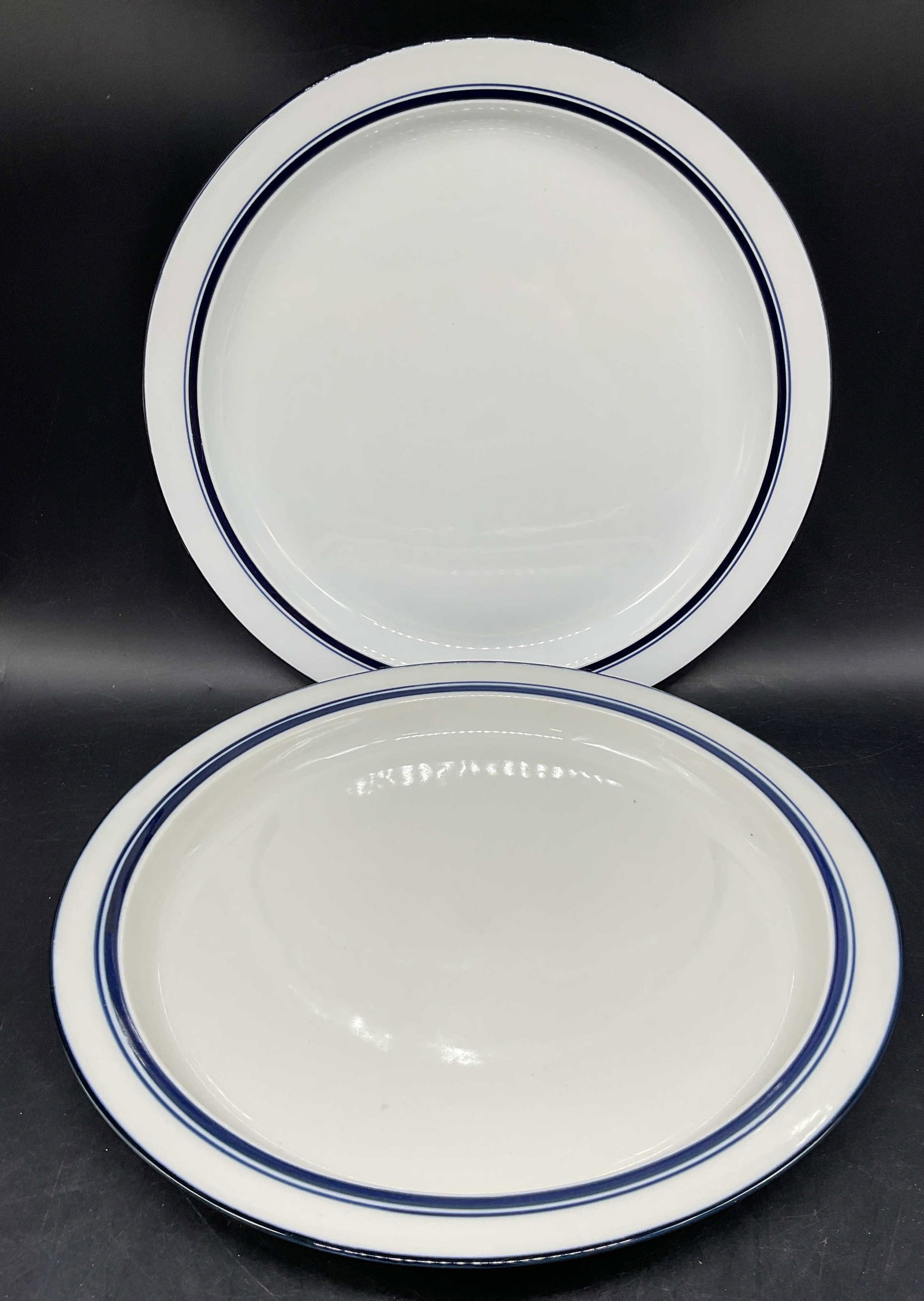 Pair DANSK Bistro Stoneware Chop Plate Platters: Pair of DANSK Bistro pattern blue and white stoneware chop plates or serving platters. Measures approx. 12.75 inches wide. Some scratching. DANSK chop plates, DANSK platter, tableware, table accessori