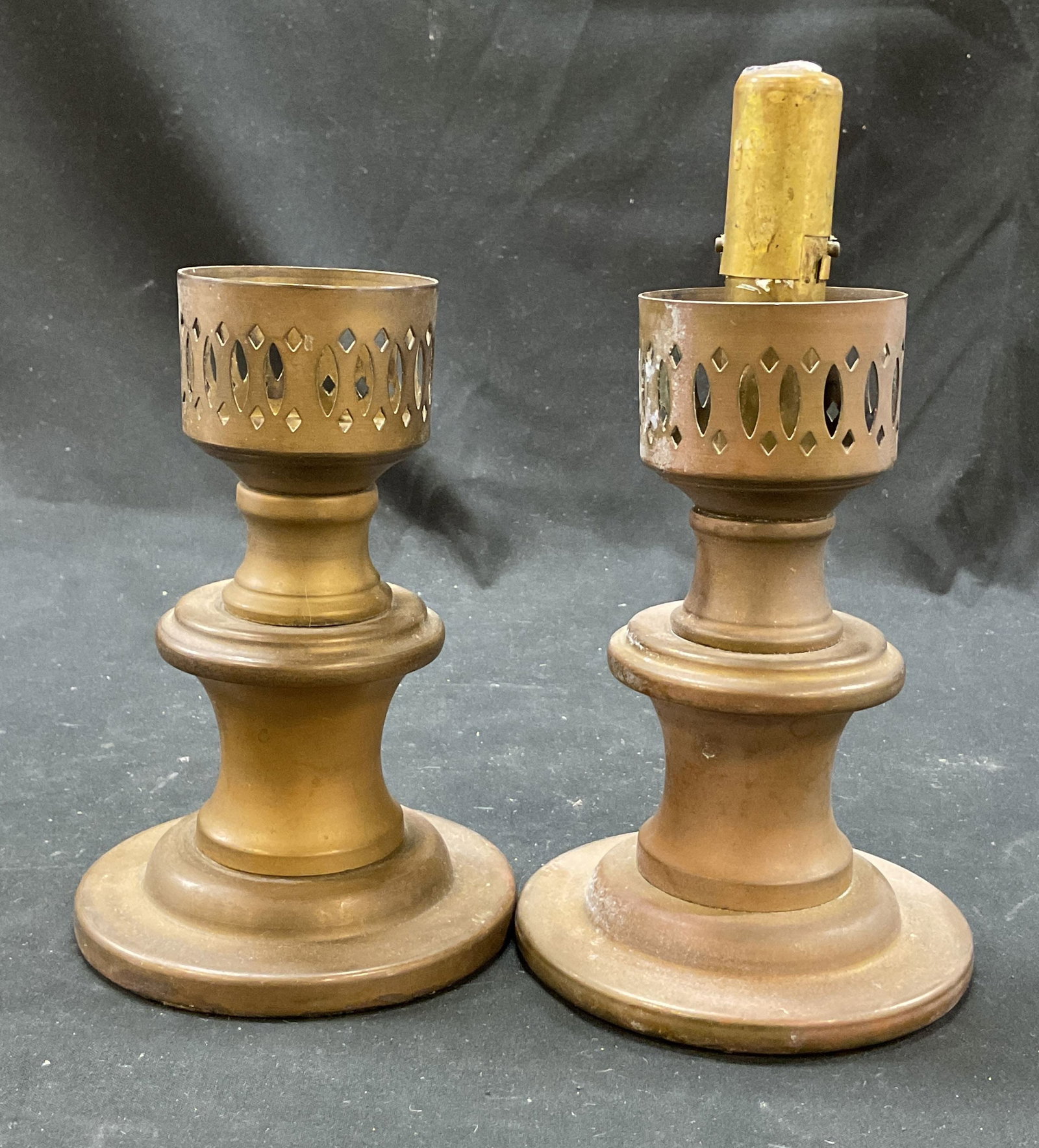 Pair Vintage Brass Candlestick Holders: Pair of vintage brass candlestick holders. Marked solid brass. Round pedestal base. Stacked stem design. Cut out geometric pattern cup. Measures ht approx 8 inches base diam approx 4 inches. Surface w