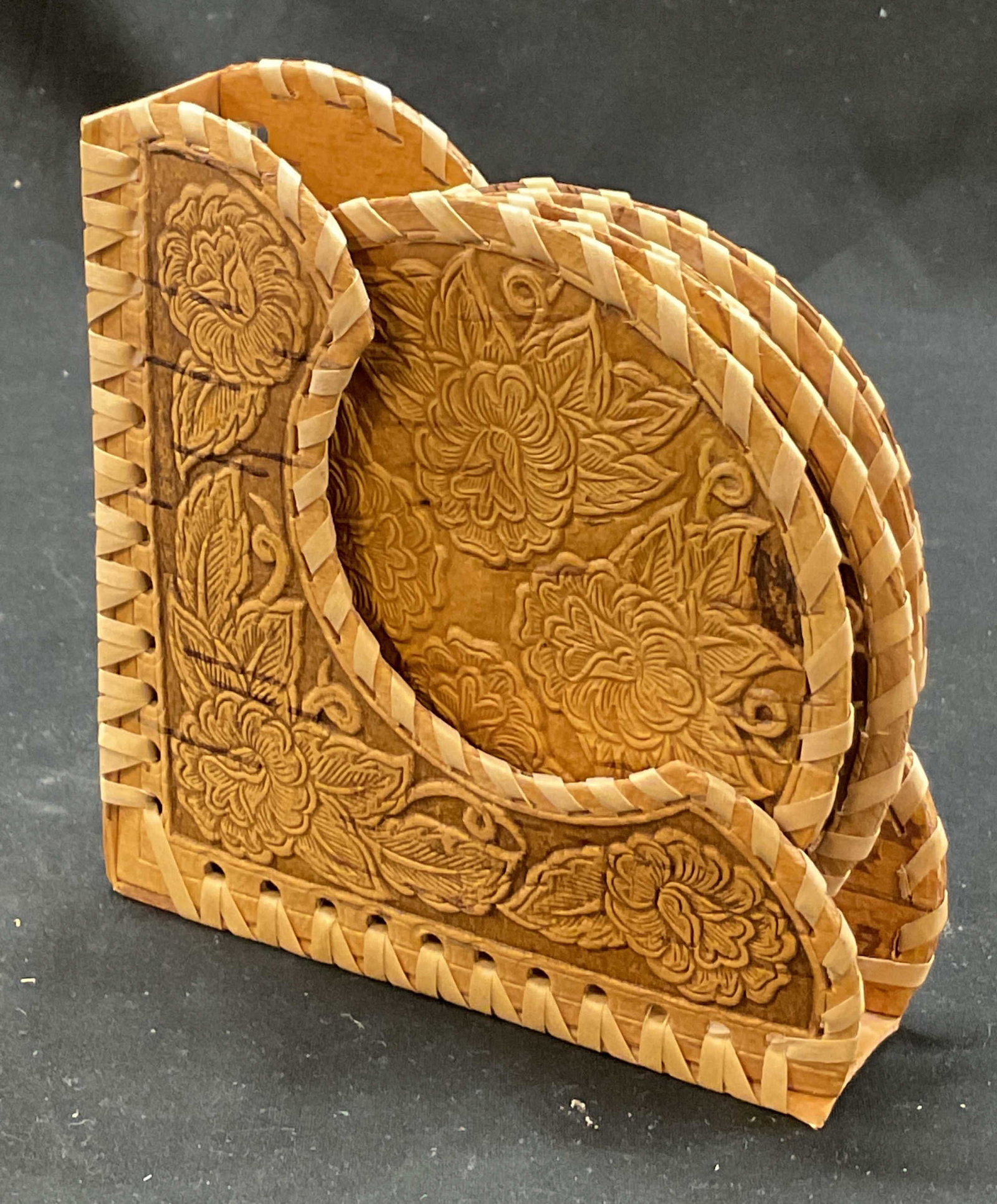 Set 6 Wooden & Woven Coasters W Holder: Set of 6 wooden and woven coasters. Circular coasters. Woven stylized border. Carved wood floral motifs. Comes with holder for coasters. Coasters measure approx 4.5 inches in diameter. Surface wear co