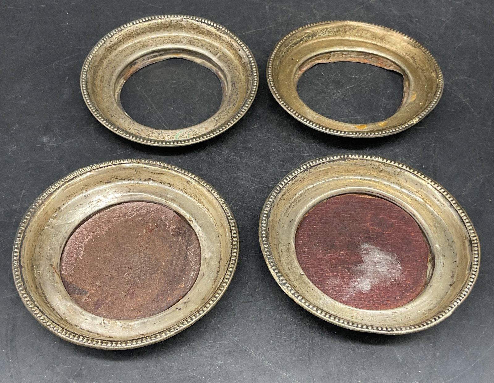 Set 4 Frank M Whiting Sterling Silver Coasters: Set of 4 vintage signed Frank M Whiting sterling silver rim coasters. Marked sterling. Measures approx. 4.25 inches wide. Two pieces have wood bases. Total weight of sterling only pieces 42 grams. Tot