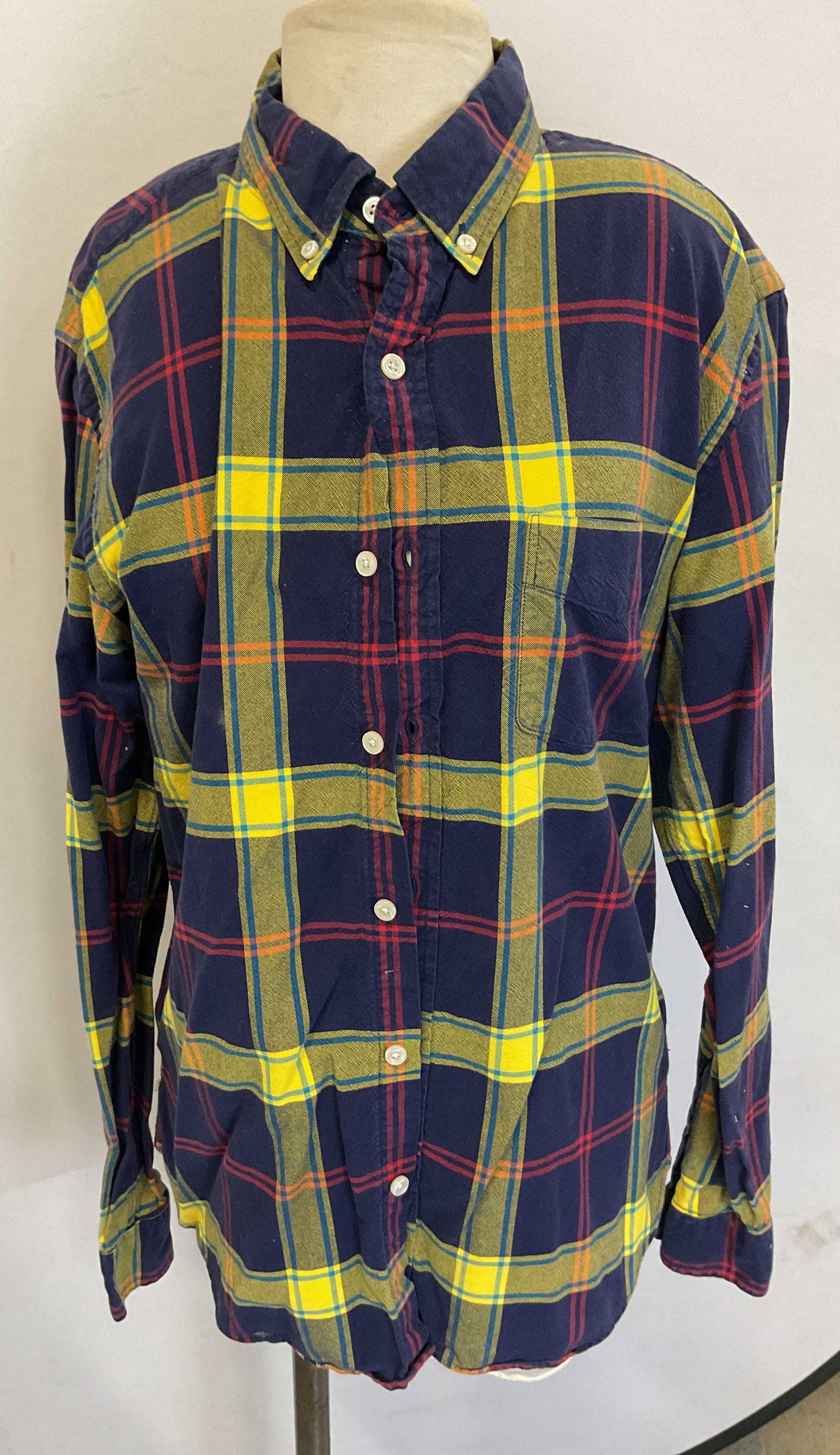 J. Crew Oxford Blue Flannel Button Down: J. Crew Oxford blue flannel button down. Size L, slim fit. Cotton material. Long sleeve with buttons along the front. Collared. Blue, yellow, and red flannel pattern. Front pocket. Wear consistent wit