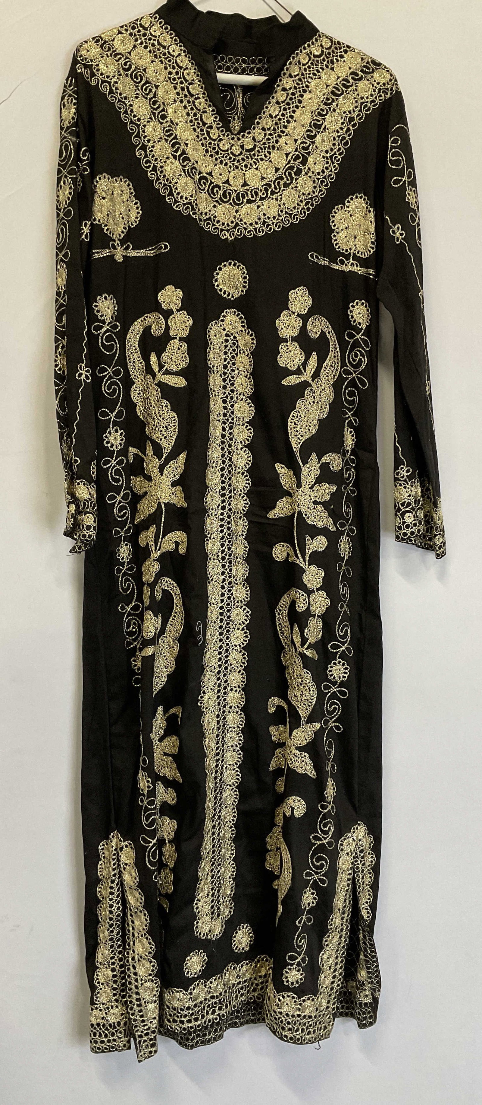 Middle-Eastern Sty Tunic with Gold Tnd Embroidery: Middle-Eastern Style Black Linen Tunic with Gold Toned Floral Embroidery. No Visible Size of Brand. Condition Consistent with Exposure. Chest Measurement app 19in. Middle Eastern Style, Middle Eastern
