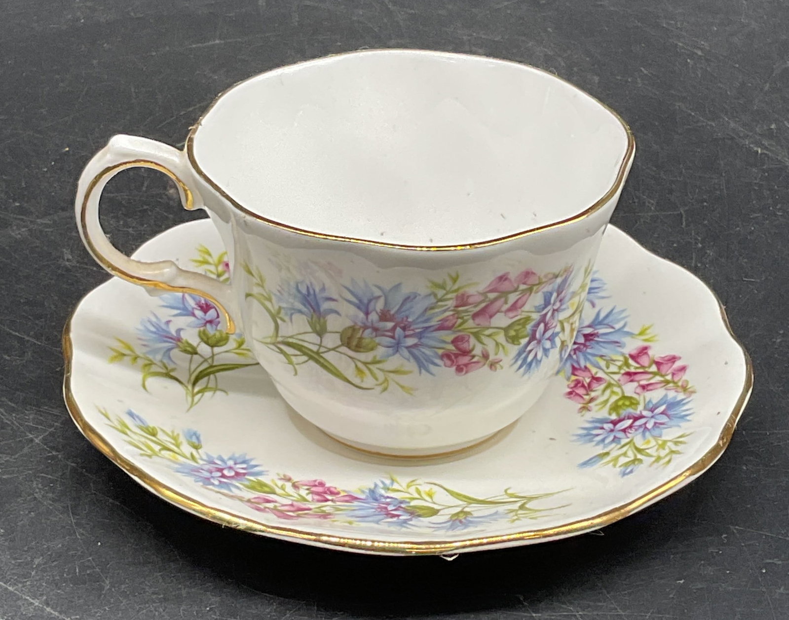 Vtg Rosina China Wild Flowers Teacup & Saucer: Vintage Rosina fine bone china teacup and saucer, Wild Flowers pattern. Made in England. Saucer measures approx. 5 inches wide. Teacup measures approx. 3 x 2.25 inches. Some crazing and scratching.