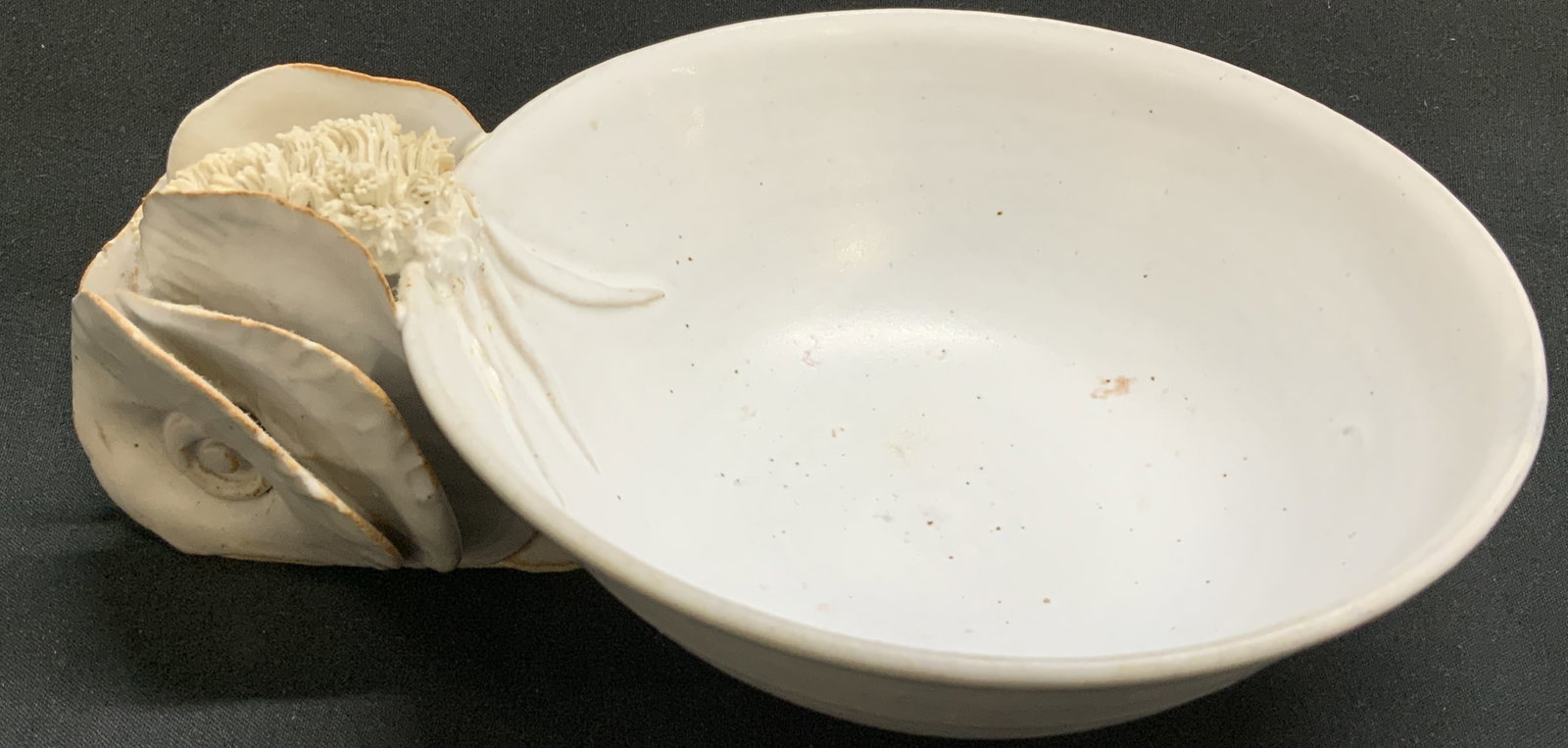 Vtg Sgnd Handcrafted Pottery Bowl: Handcrafted pottery bowl featuring a shell like form handle. White toned. Round base. Surface wear consistent to age, use & exposure. Signed & marked. Not legible. Sold as is. Measurements to handle: 