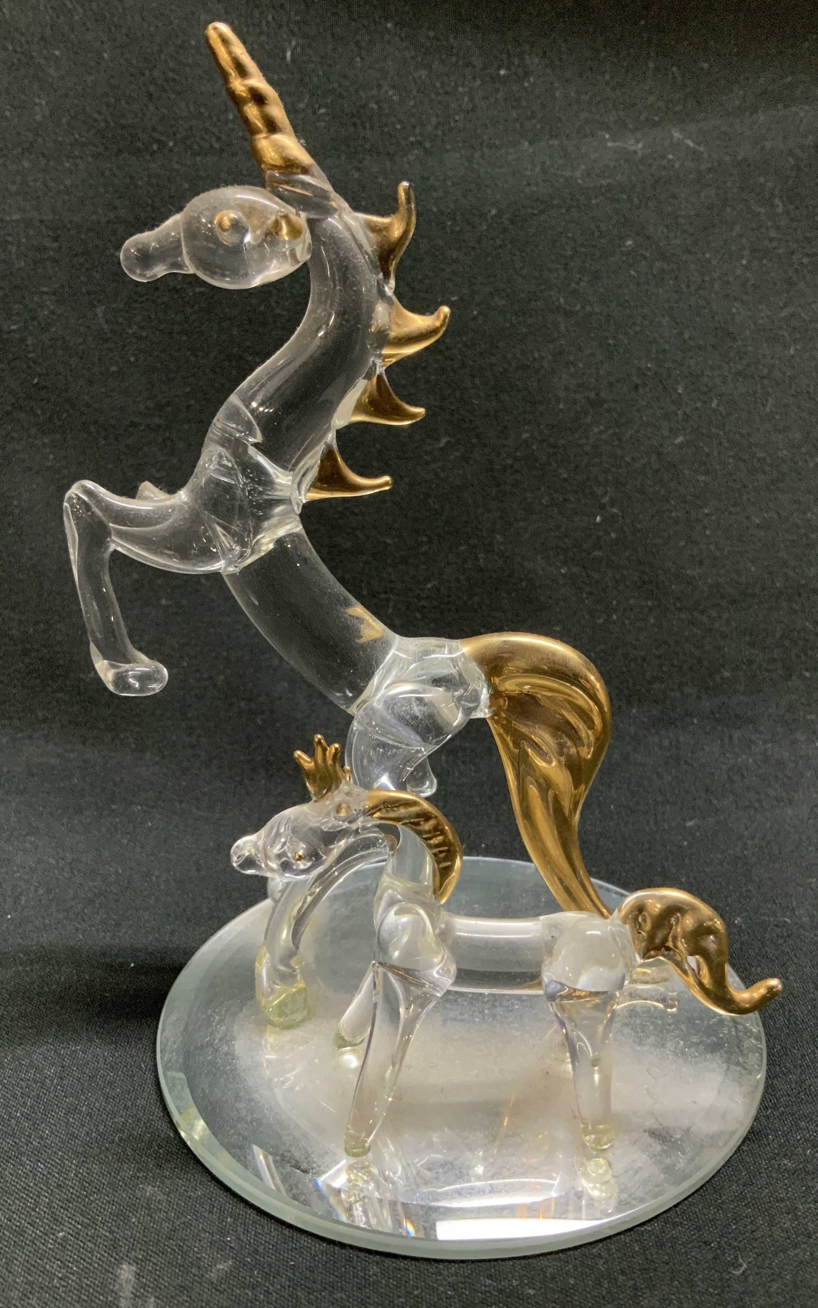 Vtg Unicorn Gilt Glass Figurine: Vintage glass unicorn figurine is in a rearing position. Smaller unicorn is standing beside. Gilt accents on horn, hair & tails. Round base. No visible signature or markings. Surface wear consistent t