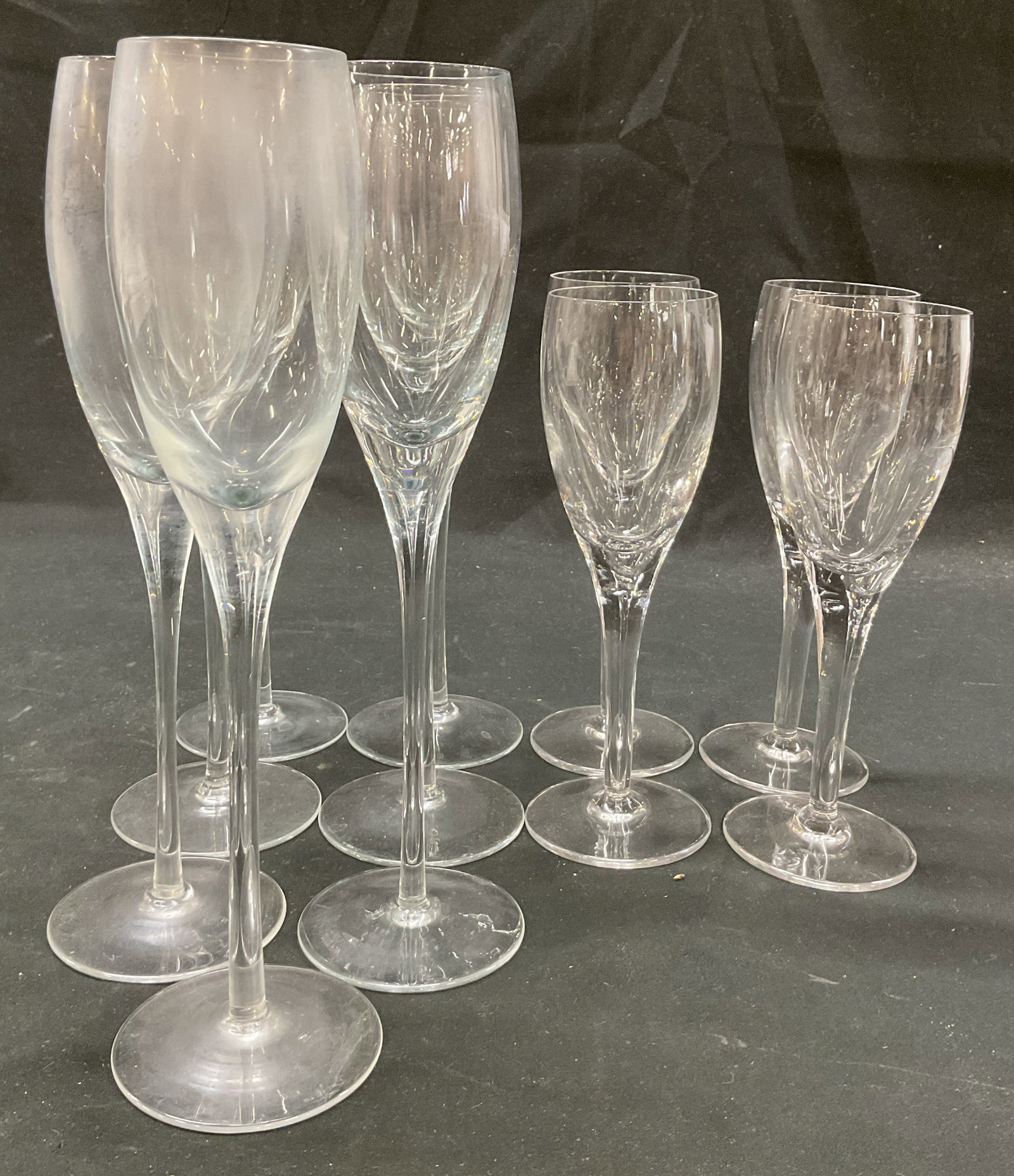 Lot 11 Vintage Crystal & Glass Champagne Flutes: Lot of 11 vintage crystal and glass champagne flutes. 7 glass champagne flutes and 4 crystal champagne flutes. Round bases, short and tall stems. Narrow body and rim. Largest measures ht approx 10 inc