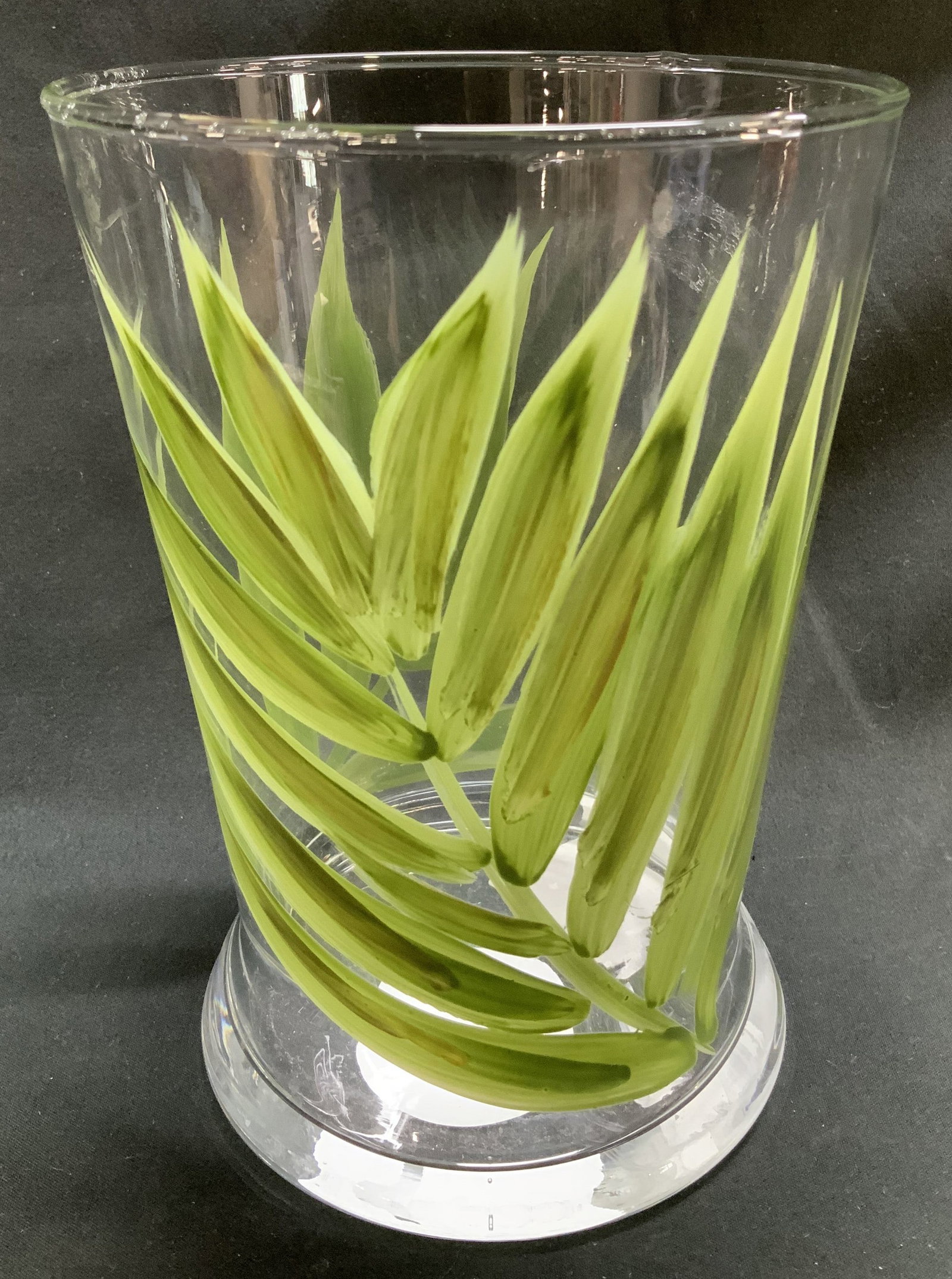 Glass Candle Holder W Leaf Motifs SLOVENIA: Glass candle holder features hand painted green leaf motifs on body. Round base. Signed & marked. Reads, Made in Slovenia. Surface wear consistent to age, use & exposure. Surface wear consistent to ag