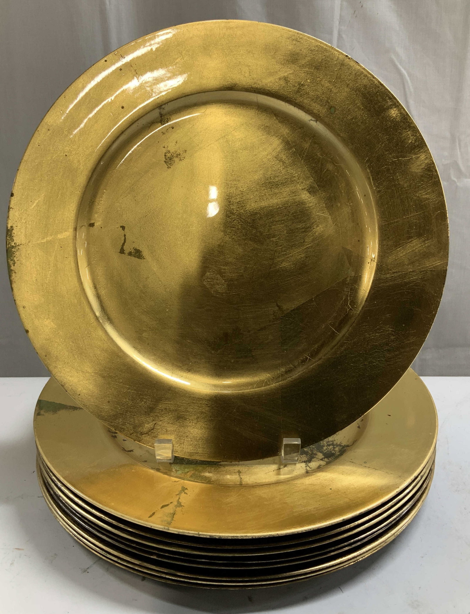Set 9 Decorative Golden Leaf Chargers: Lot includes, set 9 of decorative golden leaf chargers. Acrylic base. Round shape. Surface wear consistent to age, use & exposure. Visible fading. Measurements: length 13in x width 13in. Decorative go