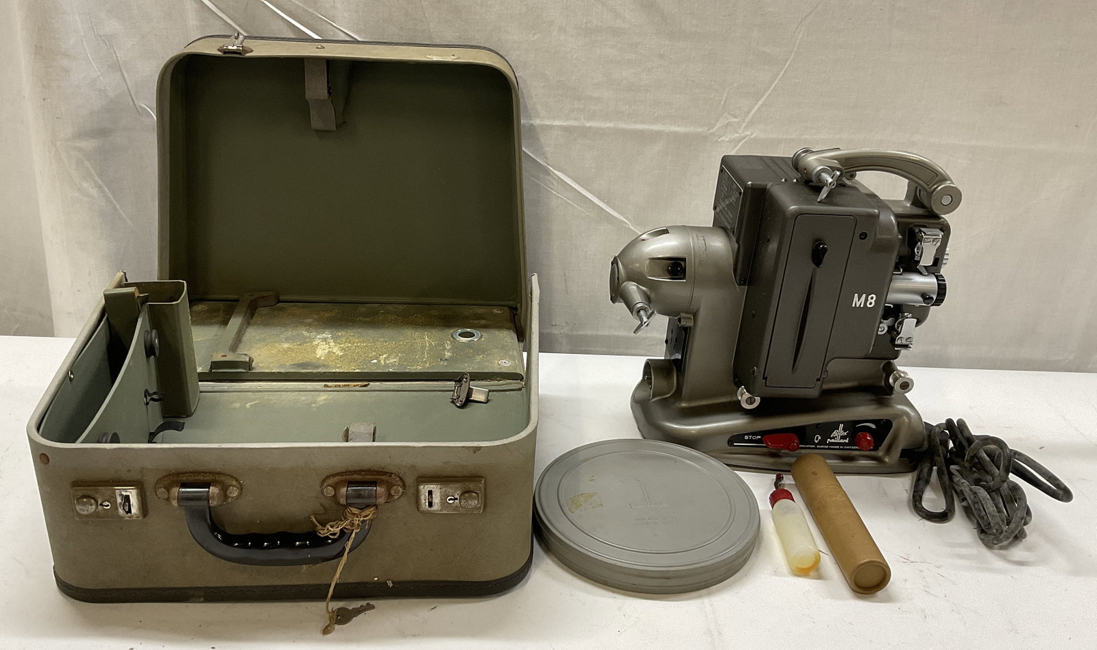 VTG Bolex Paillard M8 8MM Movie Projector+ SWITZ: Vintage 50s-60s Bolex Paillard M8 8MM Movie Projector with Original Hard Case. Bottom Reads # 380202. Made of Metal Fabrication in Switzerland. Includes Film Cannister and Oil. Projector Measures app 