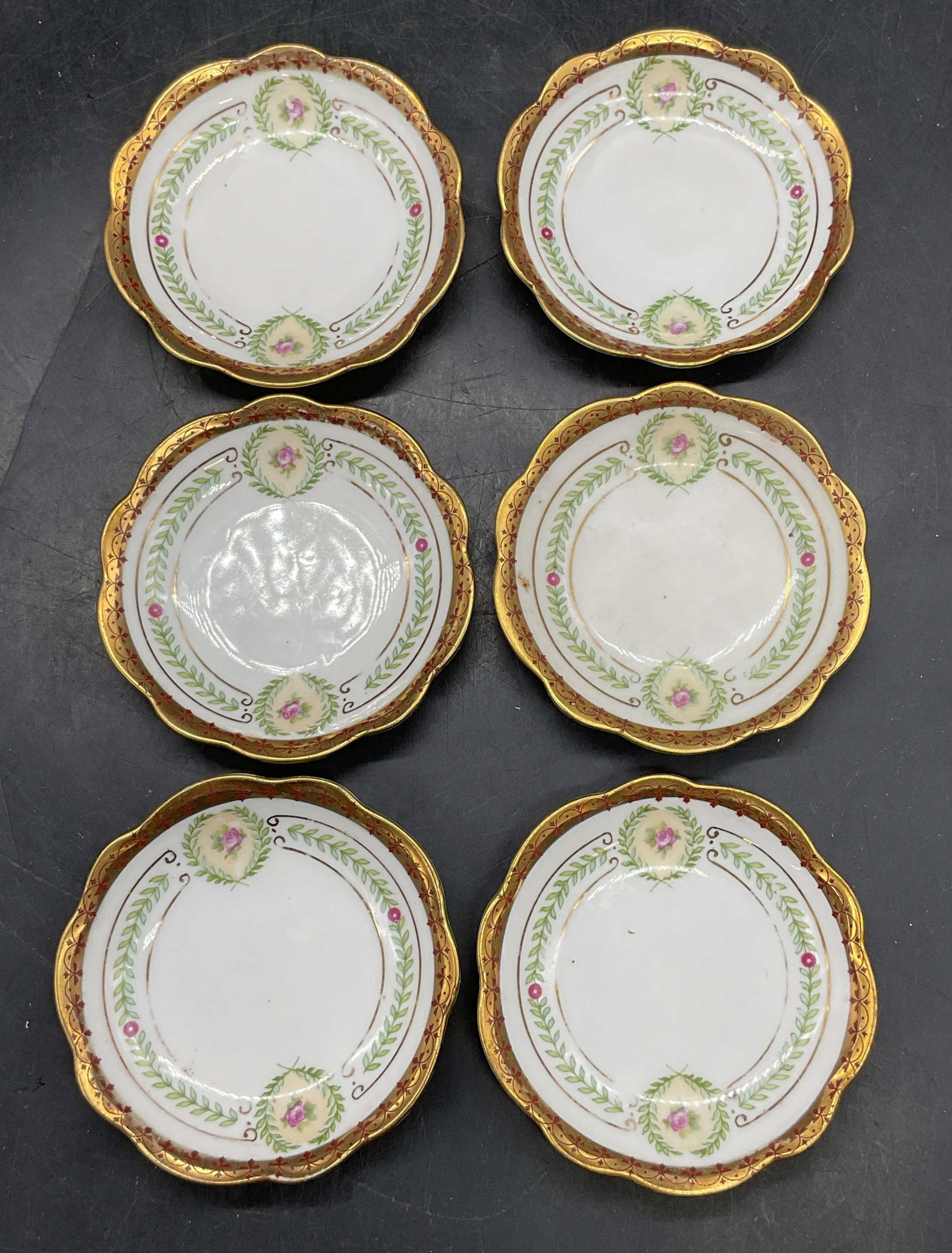 6 Antq Hutschenreuther Habsburg Porc Plates: Set of 6 antique Hutschenreuther Habsburg porcelain plates. Hand painted and gilt floral motifs. Made in Germany. Measures approx. 3 inches wide. Salt, condiment, butter, tea bag rest plates. Some scr