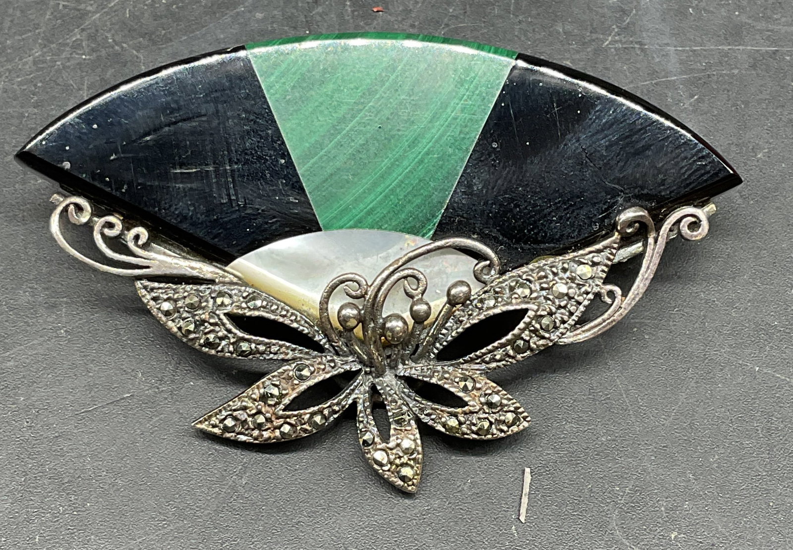 Sterling Silver, Onyx, Malachite Fan Brooch: Vintage sterling silver fan brooch with onyx, malachite, mother of pearl, and marcasite. Marked sterling. Measures approx. 1.5 x 2.5 inches. Total weight 25.4 grams. Some scratching. Jewelry, estate j
