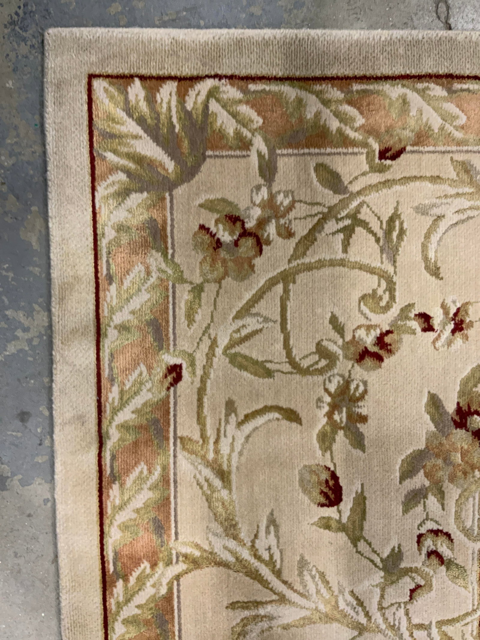 NOURISON GRAND CHALET Oversized Wool Rug: Tag on underside reads NOURISON GRAND CHALET. Rug is wool as states on tag. Piece has multi toned floral, scroll and leaf detailing. Rug is oversized measuring approximately 13 feet by 9 ft 6 inches. 
