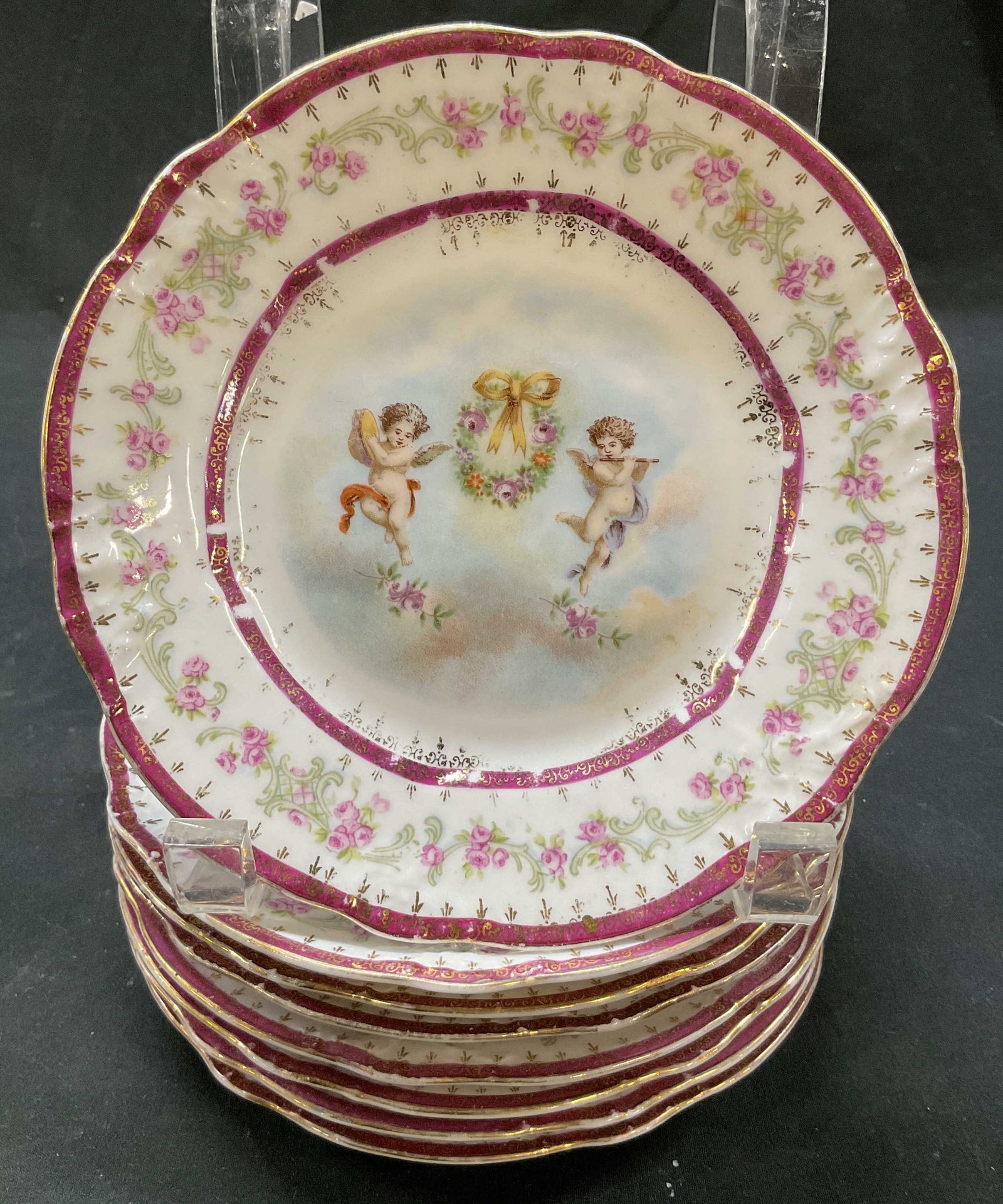 Set 8 Carl Tielsch Cherub Porc Plates Germany: Set of 8 Carl Tielsch cherub porcelain plates. Marked on underside, reads CT Germany. Scalloped edge. Cherub motifs with floral wreath. Various floral and scroll motifs. Varying colors with gilt accen