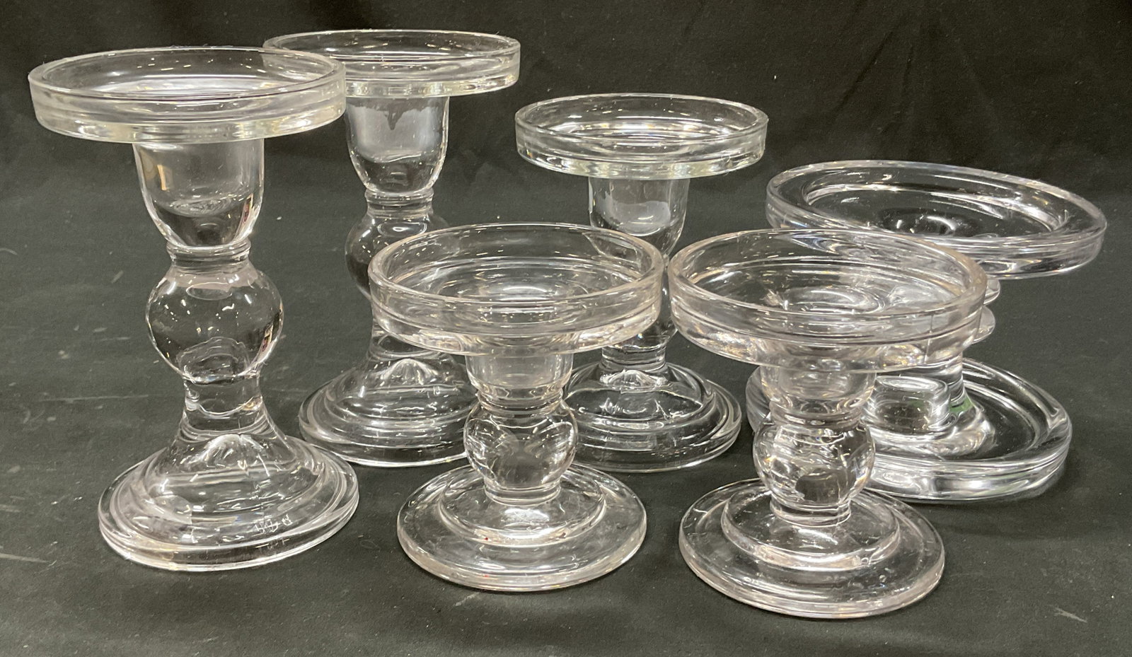 Lot 6 Vintage Glass Pillar Candle Holders: Lot of 6 vintage glass pillar candle holders. Round base. Stacked ball design stems. Round top. Sizes and shape vary. Largest measures ht approx 5.5 inches diam approx 3.5 inches. Some scratching. Can