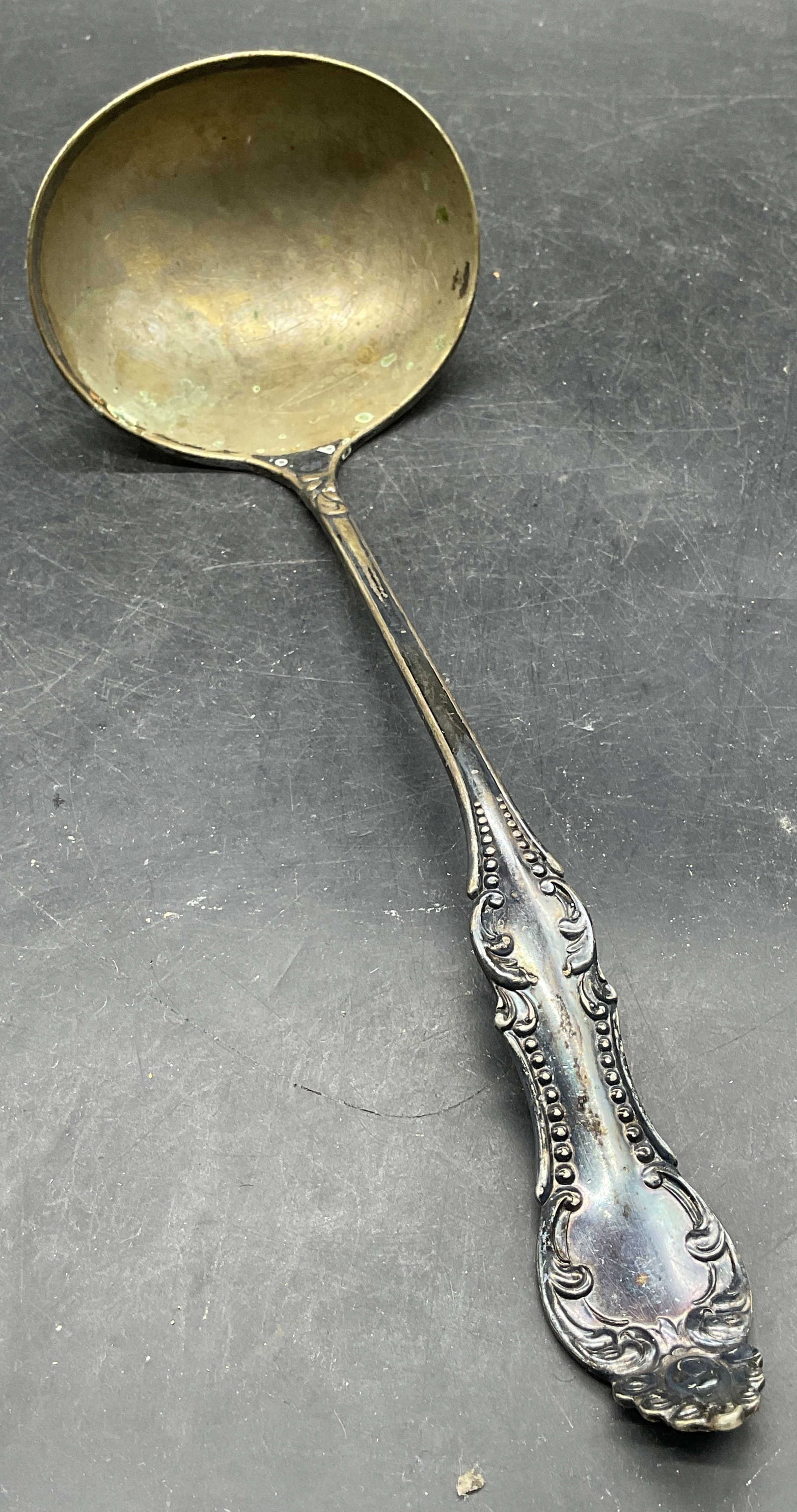 Vintage Rogers Silver Plated Ladle: Vintage Rogers silver plated ladle. Ornate scroll pattern handle. Measures approx. 10.5 inches long. Wear including patina, scratching, residue. Rogers ladle, vintage ladle, silver plated ladle, table