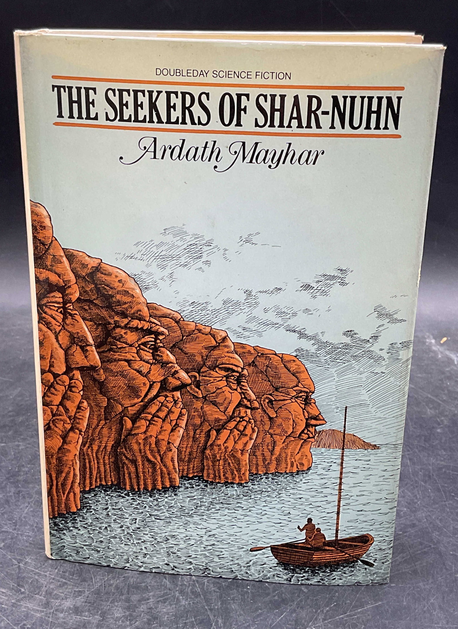 1980 Mayhar Seekers of Shar Nuhn 1st Edition: Hardcover first edition copy of The Seekers of Shar Nuhn by Ardath Mayhar. Doubleday, 1980. Measures approx 8.5 x 5.75 inches. Some wear to cover, pages, and binding consistent with exposure. Book, vi