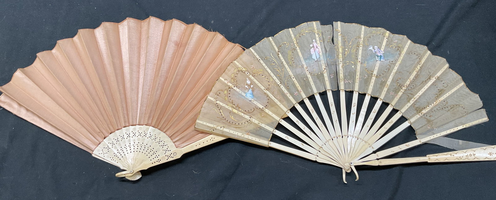 Lot 2 Antique Decorative Folding Hand Fan: Lot of 2 antique decorative folding hand fans. Bamboo and fabric materials. Light peach colored fan. Sheer fan with ornate gilt decorations and sequins. Hand painted floral and figure motifs. Dressed 