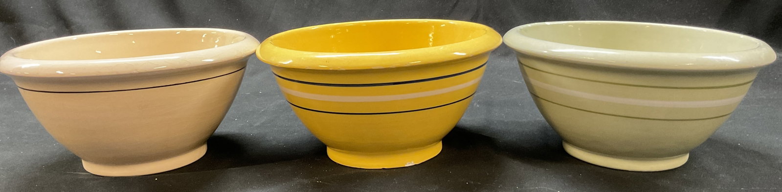 Lot 3 Terramoto Ceramic Bowls USA: Lot of 3 Terramoto ceramic bowls. Marked on underside, reads Terramoto San Francisco. Round bowls. Comes in green, yellow, and cream colored. Line pattern in white, blue, and green. Round base. Measur