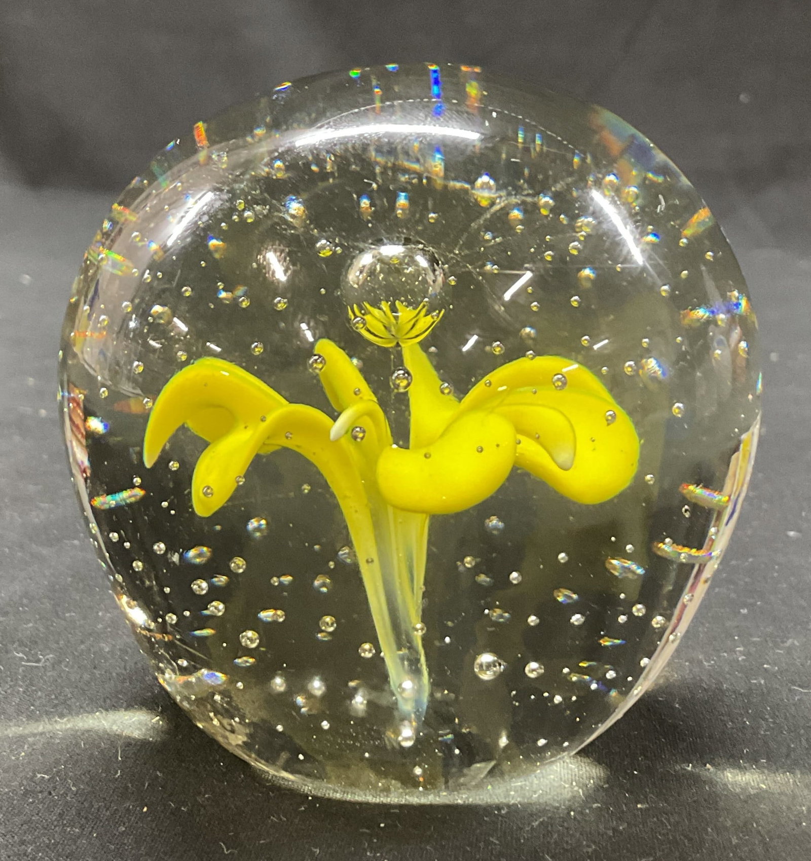 Vintage Hand Blown Glass Floral Paperweight: Vintage hand blown glass floral paperweight. Sphere shape with abstract floral motif in yellow. Controlled air bubble design. Measures ht approx 3.5 inches diam approx 2 inches. Some scratching. Paper