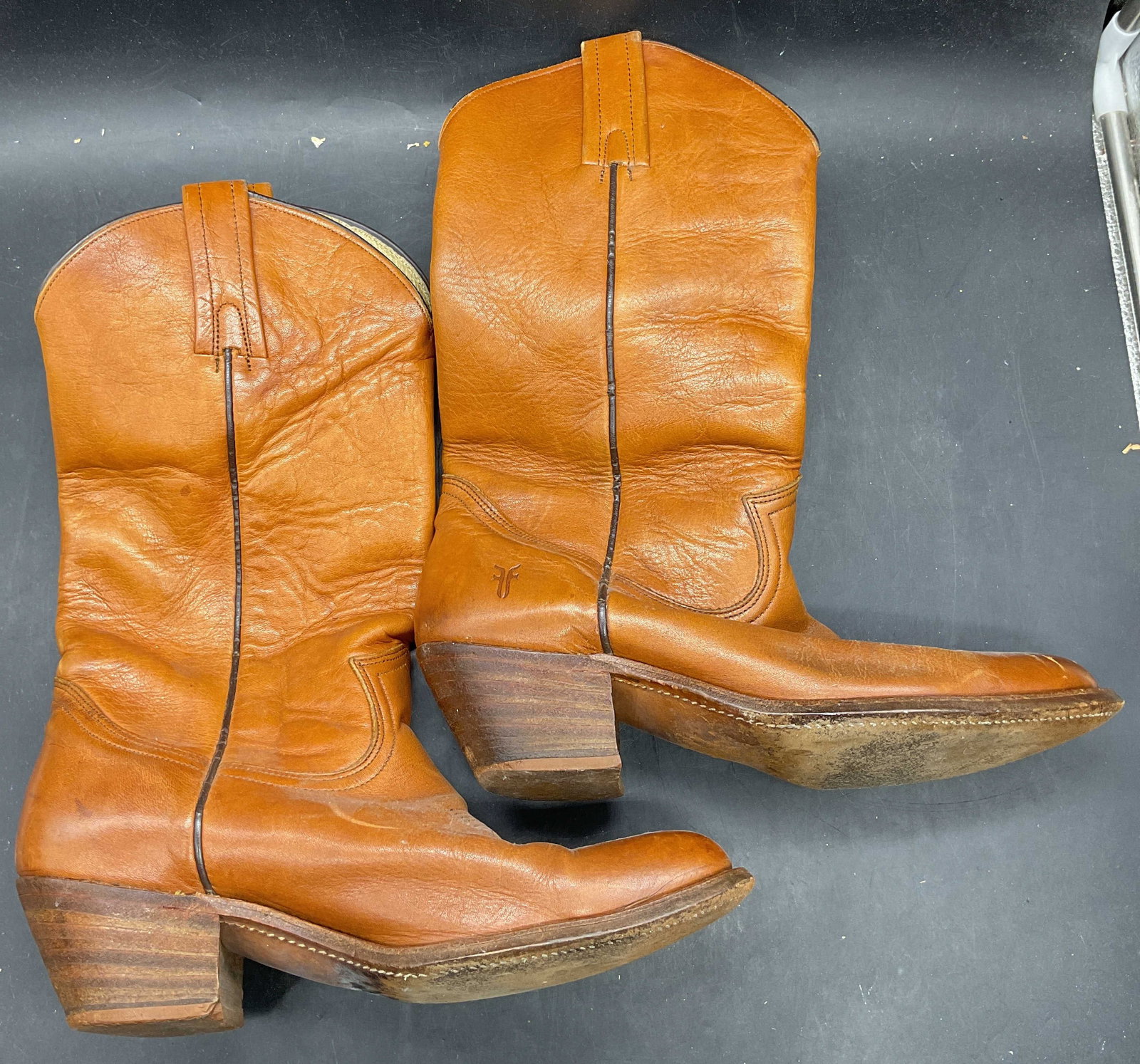 Frye Tan Leather Western Boots: Frye tan leather western style boots. Size 9.5. Wear including scuffing, scratching, creasing. Frye boots, leather boots, tan boots, western boots, cowboy boots, designer boots, wearables, 10 cs