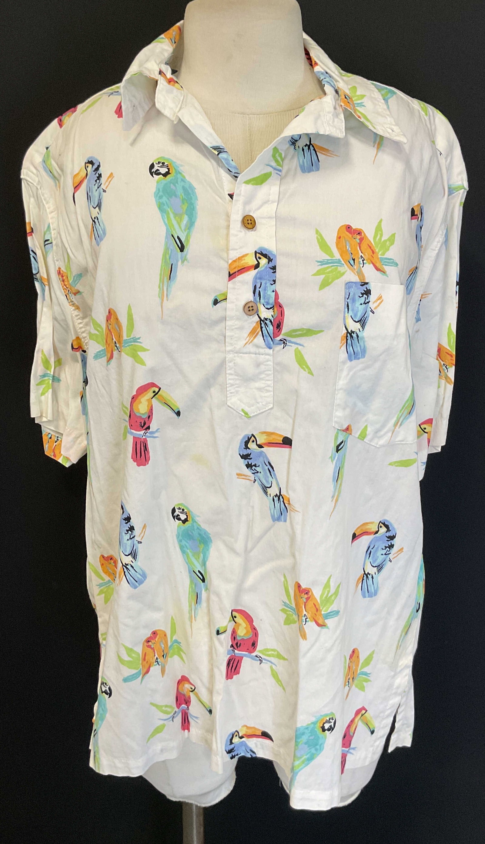 Chubbies White Parrot Polo Shirt USA: Chubbies white parrot polo shirt. Tag reads The Nutter From Chubbies. Made in USA. Size M. Cotton material. Collared with buttons. Front pocket. Parrot and various bird motifs in varying colors. Wear 