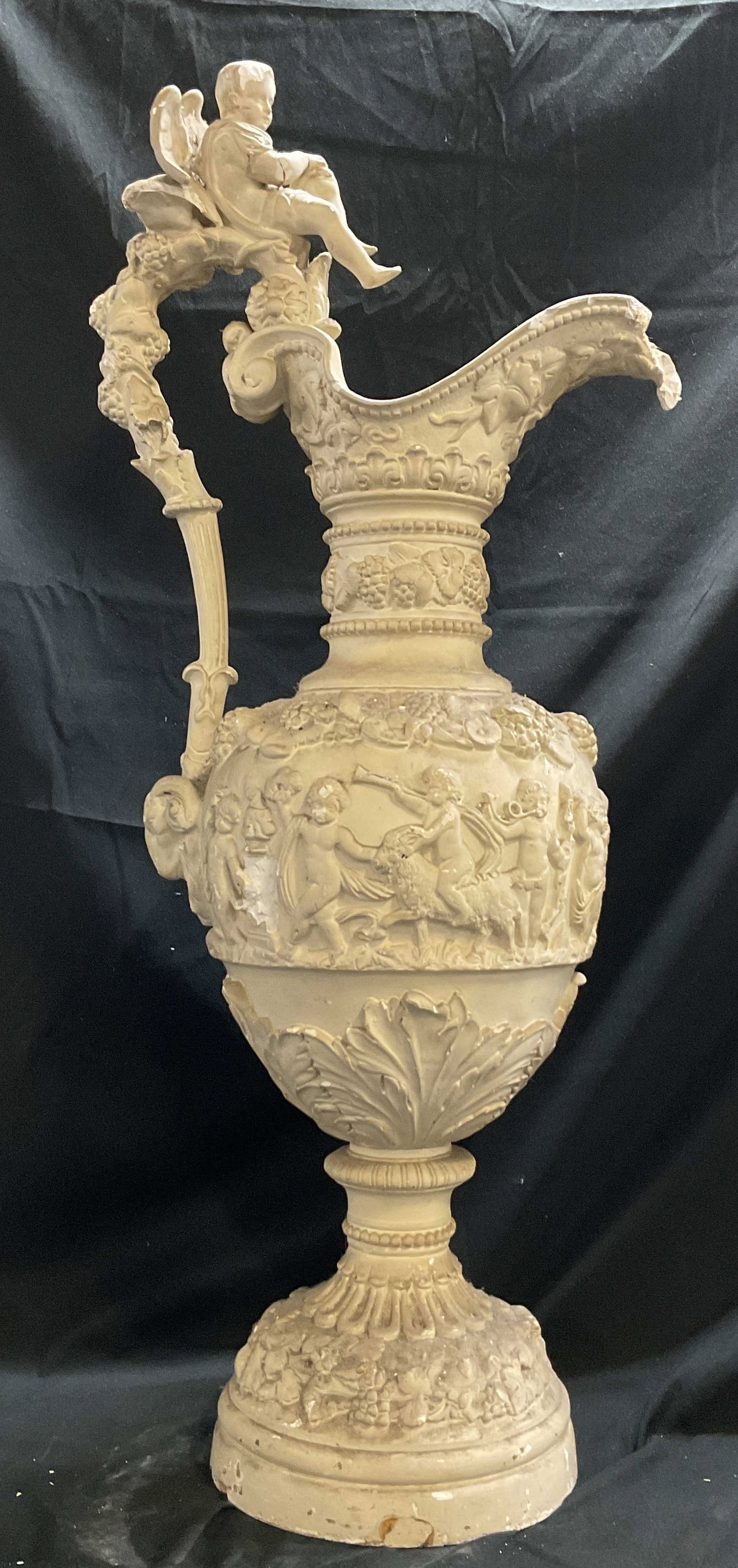 Vintage Ornate Classical Cherub XL Pitcher 35in: Vintage ornate classical cherub plaster extra large decorative pitcher. Classical style ornate design with raised cherub, scroll, and grapevine motifs. Includes painted white wooden base. Curved shape