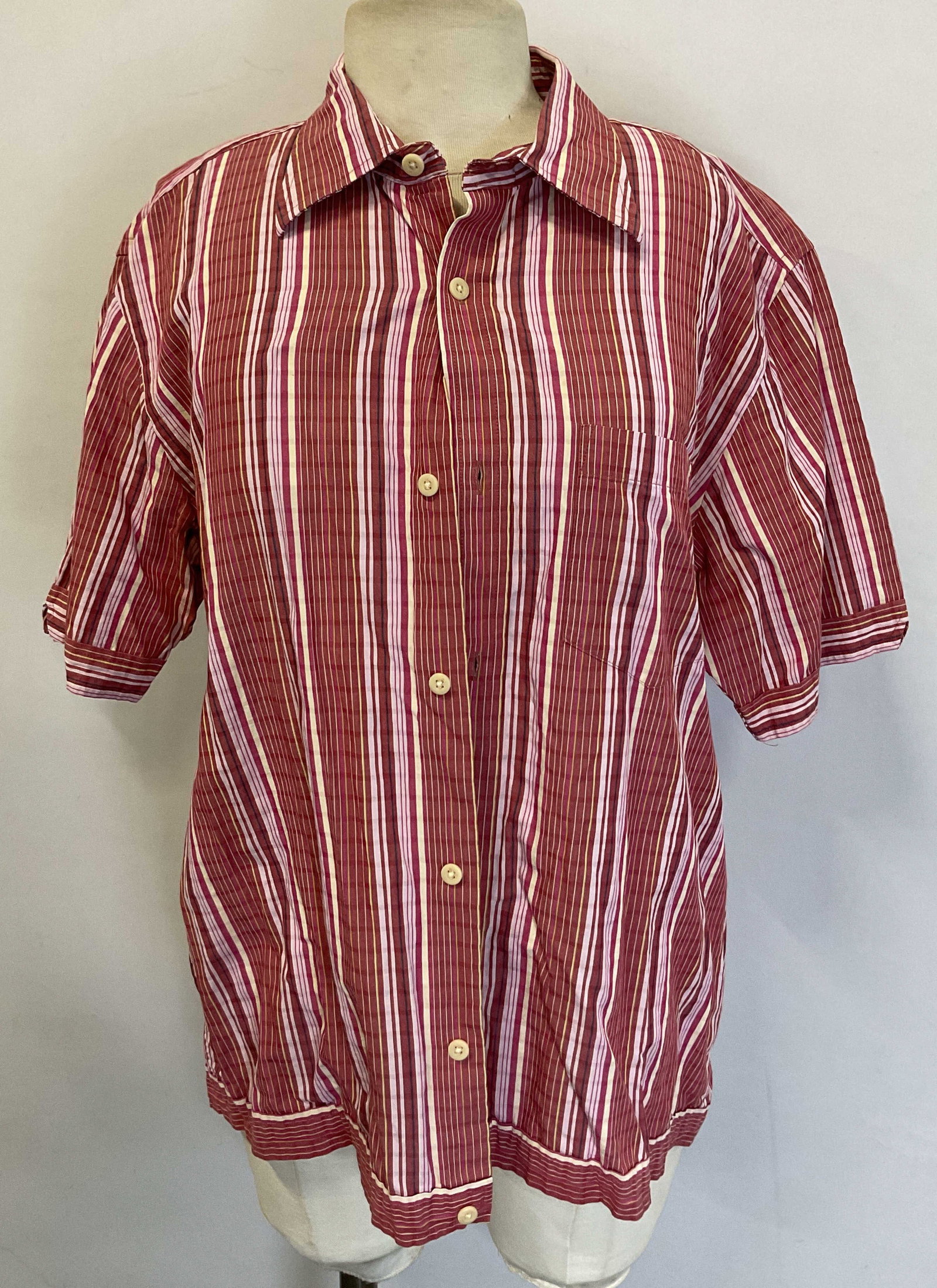 Joseph Abboud Pink Striped Button Down Hong Kong: Joseph Abboud pink striped button down shirt. Made in Hong Kong. Size M. Cotton material. Short sleeve. Collared and buttons. Front pocket. Striped pattern in pink, red, and white. Wear consistent