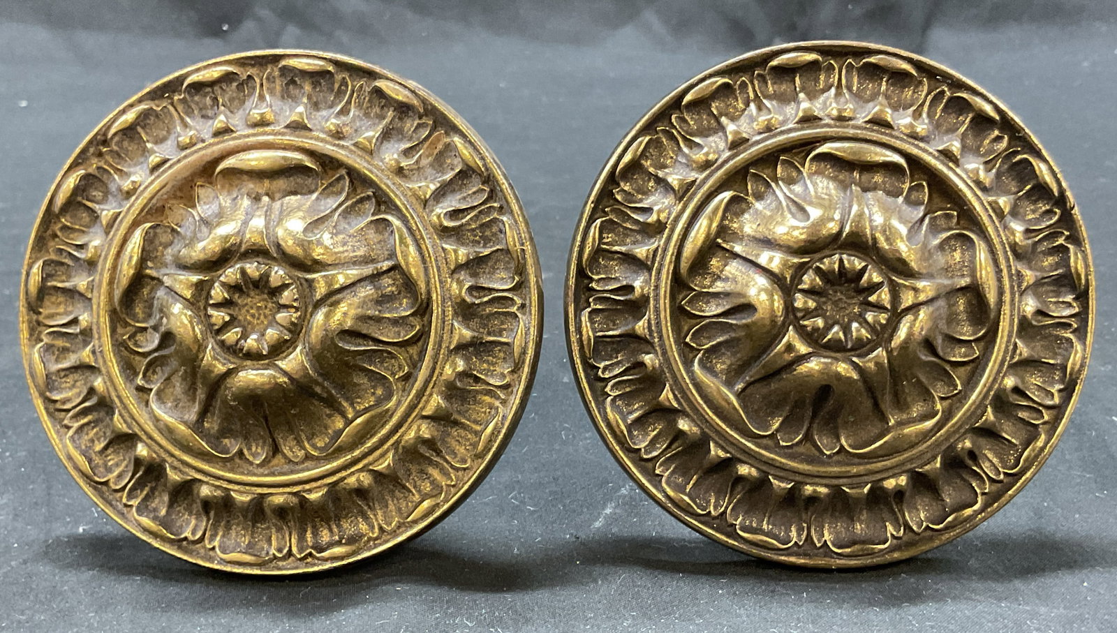 Pair Vintage Circular Embossed Brass Tie Backs: Pair of vintage circular embossed brass tie backs. Embossed pattern. Measures approx 4 x 4.5 inches. Surface wear consistent with exposure. Tie backs, decor, home decor, home accessories, antiques, co