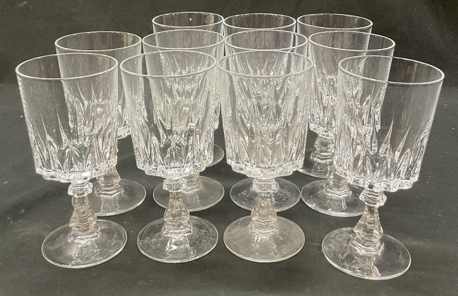Set 11 Cristal DArques Louvre Crys Wine Glasses: Set of 11 Cristal DArques Louvre crystal wine glasses. Round base with faceted stem. Ribbed surface. Ornate design. Measures ht approx 5.5 inches diam approx 2.5 inches. Some scratching. Wine glasses,
