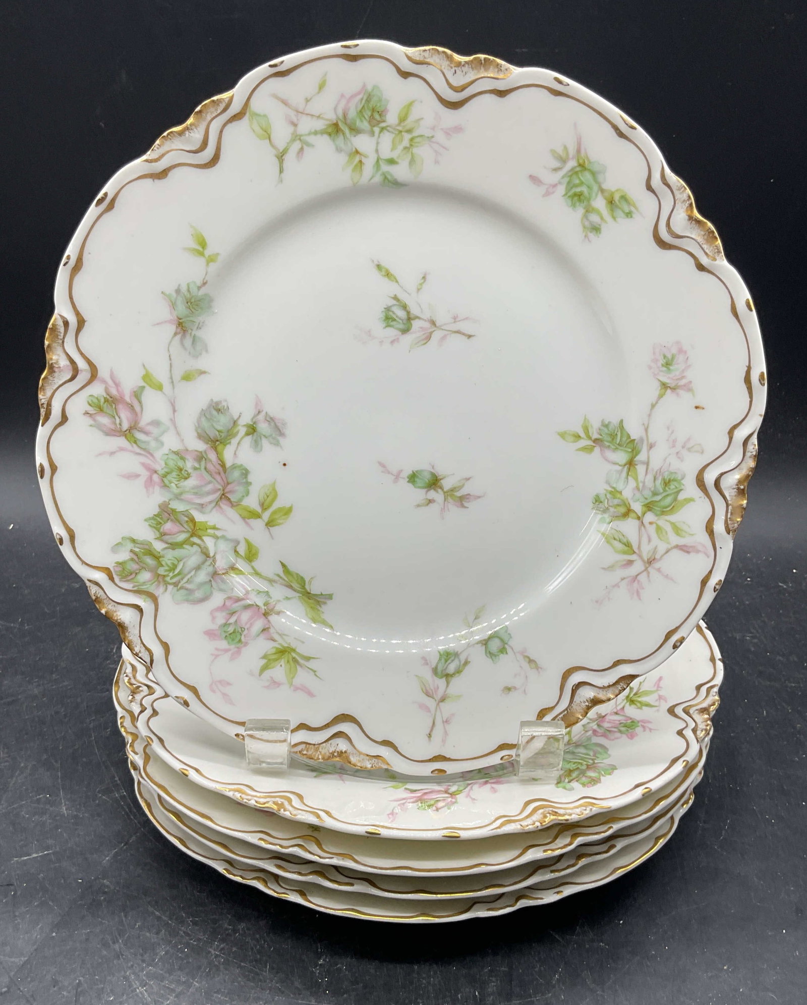 5 Antq HAVILAND Limoges Porc Floral Plates France: Near matching set of 5 antique and vintage HAVILAND Limoges porcelain plates. Made in France. Hand painted and gilt with floral motifs. 3 pieces marked The Charonne. Measures approx. 8.5 inches wide. 