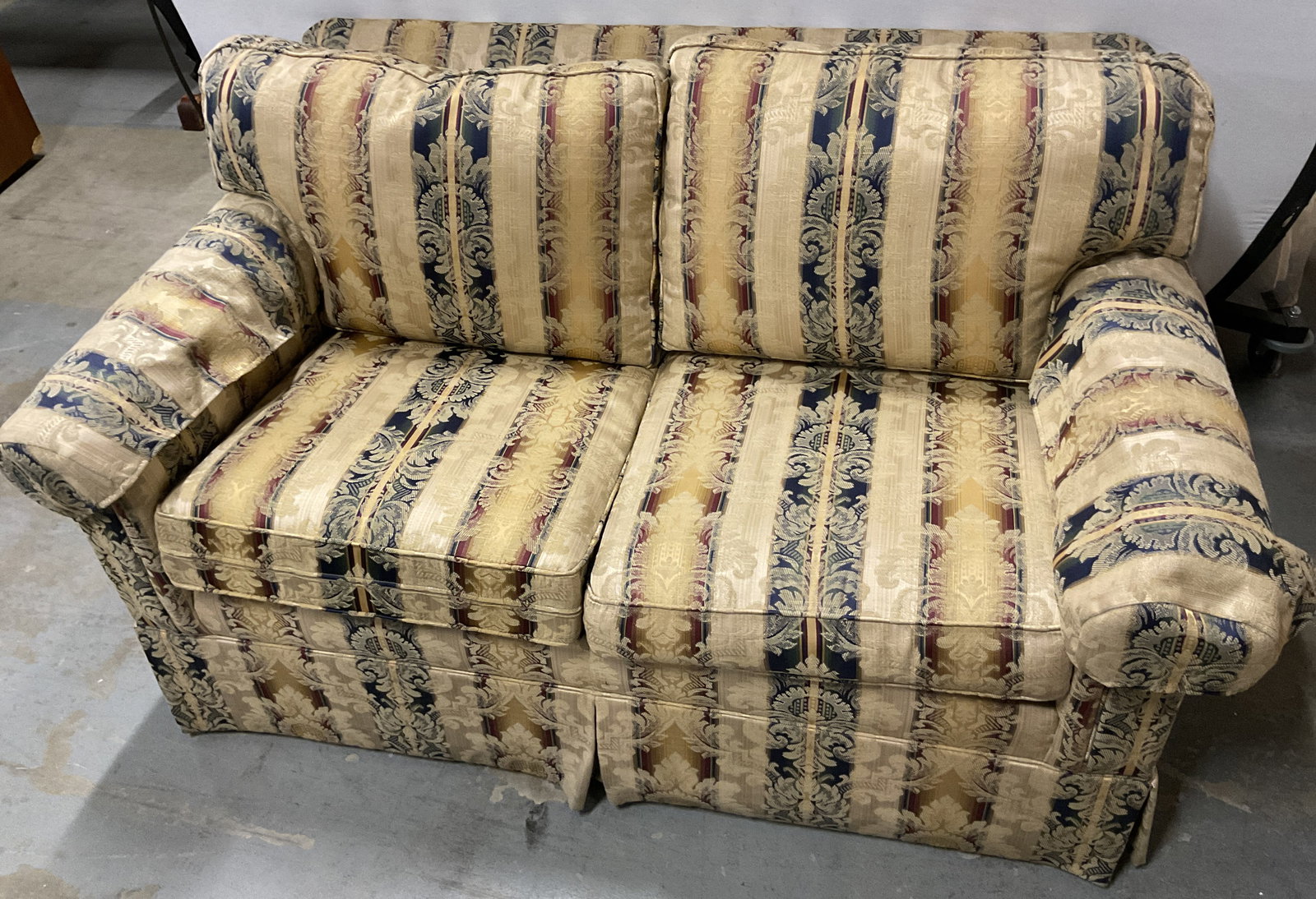 Ethan Allen Upholstered Damask Striped Loveseat: Ethan Allen upholstered damask striped loveseat. Reads Ethan Allen underneath cushion. Striped pattern in varying colors. Ornate leaf and scroll motifs. Cushioned backrest and seat. Covered armrests. 