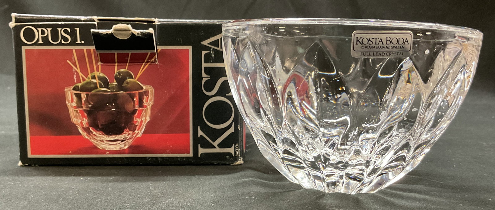 Kosta Boda Opus Crystal Bowl Sweden W Box: Kosta Boda Opus crystal bowl. Comes with original box. Marked on surface with sticker. Made in Sweden. Designed by Rolf Sinnemark. Cut fan pattern. Measures ht approx 3 inches diam approx 4.5 inches. 