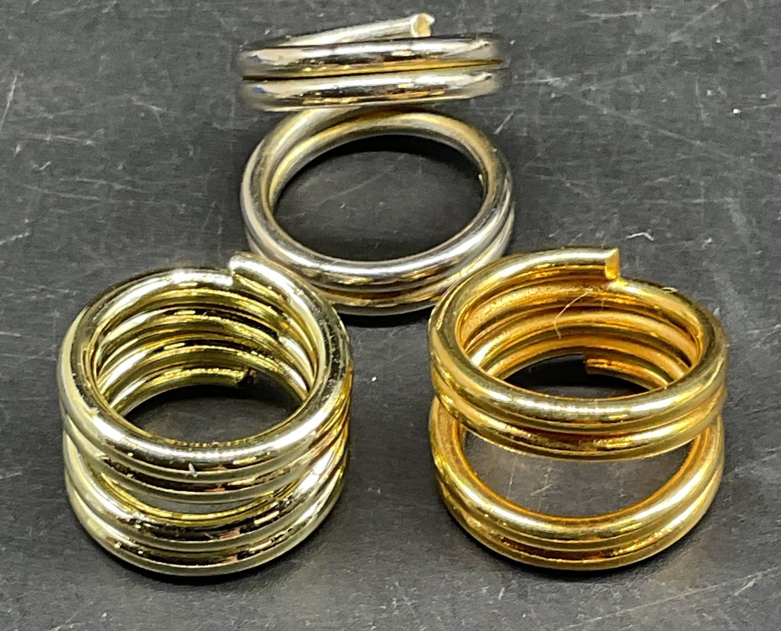 Lot 3 Gold & Silver Tone Coiled Rings: Lot of 3 gold and silver tone coiled band rings. Largest ring size 4.75. Some scratching. Jewelry, estate jewelry, costume jewelry, cocktail jewelry, fashion jewelry, accessories, fashion