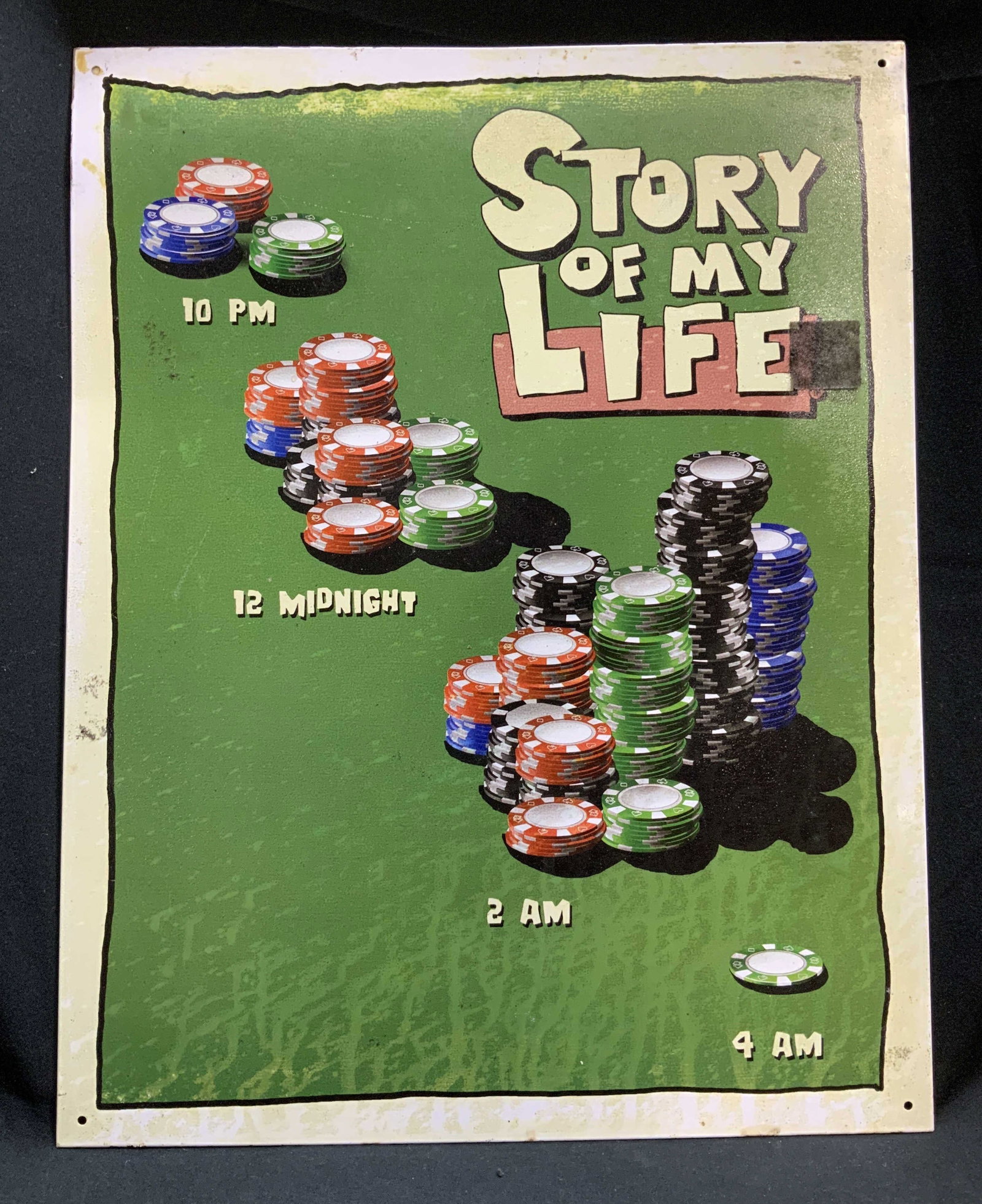 Jim Baldwin Story of My Life Poker Tin Sign USA: Jim Baldwin tin sign featuring a Story of My Life poker theme. Illustrations of stacks of casino chips. Reads, 10pm, 12 midnight, 2am & 4am. Signed & marked. Reads, Jim Baldwin. Manufactured by Desper
