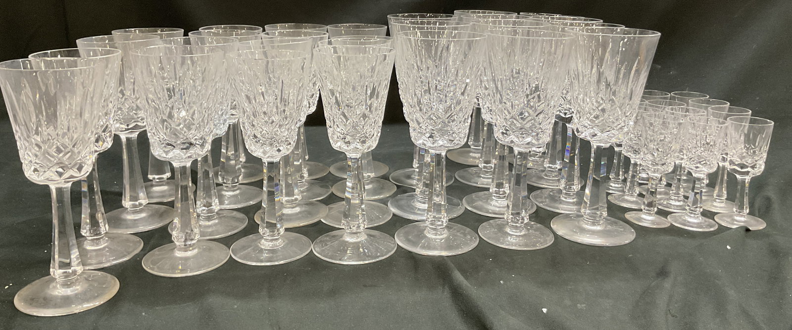 Set 38 Assorted Crystal Wine Glasses: Set of 38 assorted crystal wine glasses. Round base. Faceted stems. Cut diamond and fan patterns. Wide rim. Size vary. Markings visible, read illegibly, one appears to read Galway. Measures ht approx 