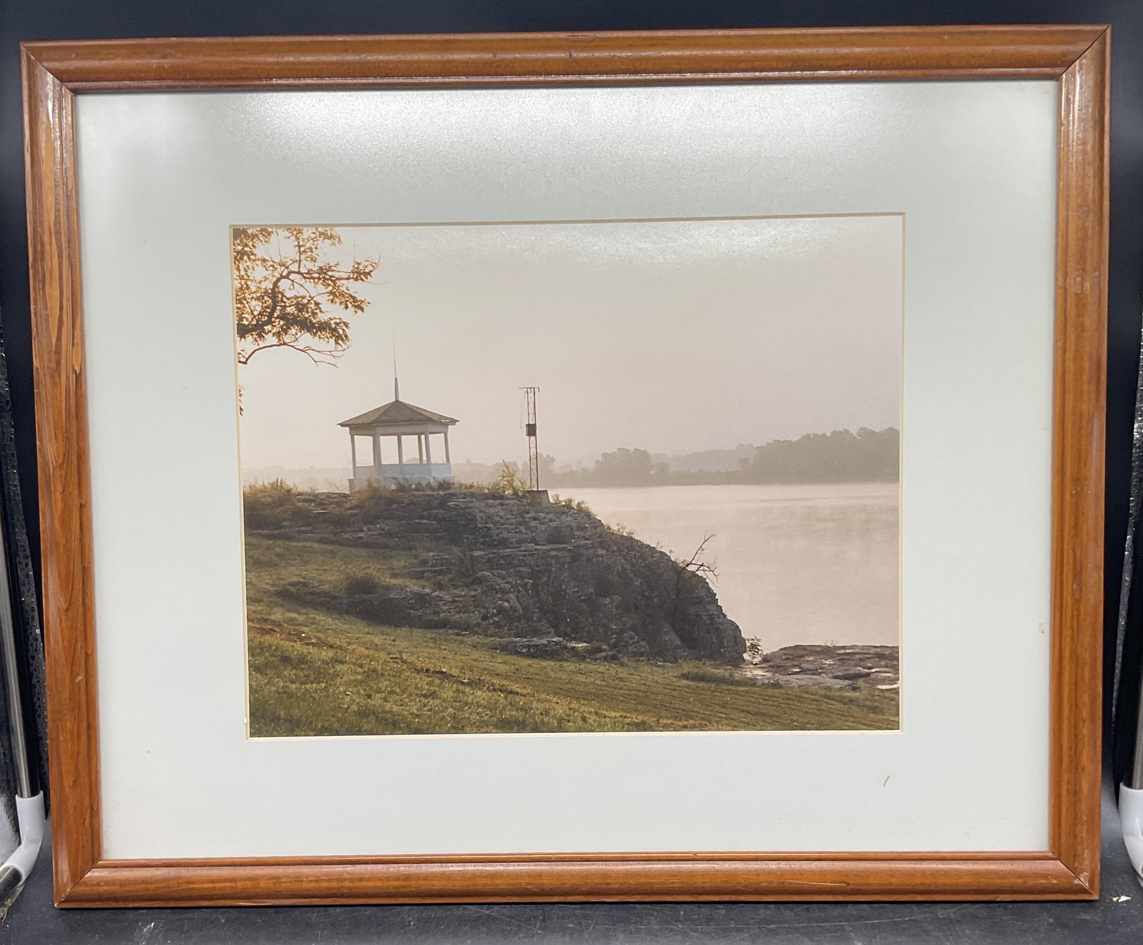 Framed Jim Moare Landscape Photo Print: Framed and matted color photo print. Inscribed on the verso A Jim Moare Original. Landscape with view of gazebo and water. Wood frame. Not examined out of frame. Frame measures approx. 17.5 x 21.5