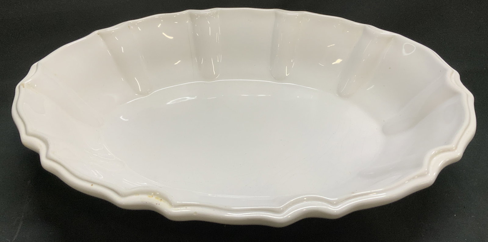 Vtg Handmade Ceramic Serving Dish ITALY: Vintage handmade ceramic serving dish features a scalloped edge. White & glossy finish. Signed & marked on underside. Reads, HANDMADE IN ITALY. Surface wear consistent to age, use & exposure.