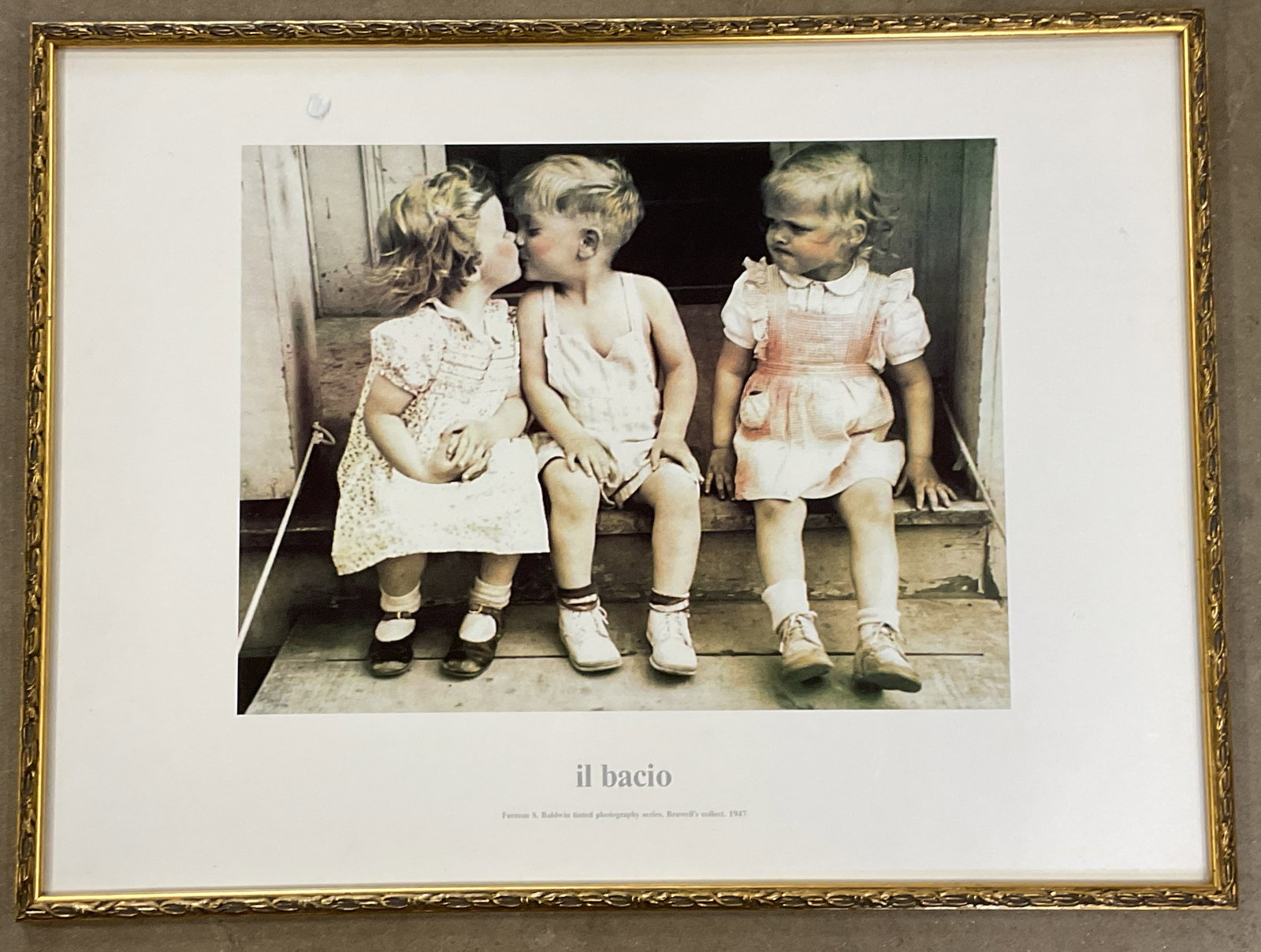 Framed After Baldwin Il Bacio Lithograph: Framed lithograph. After Furman S Baldwin. Il Bacio. Children. Gilt wood frame. Not examined out of frame. Frame measures approx. 18 x 24 inches. Some wear consistent with exposure. Art, fine art