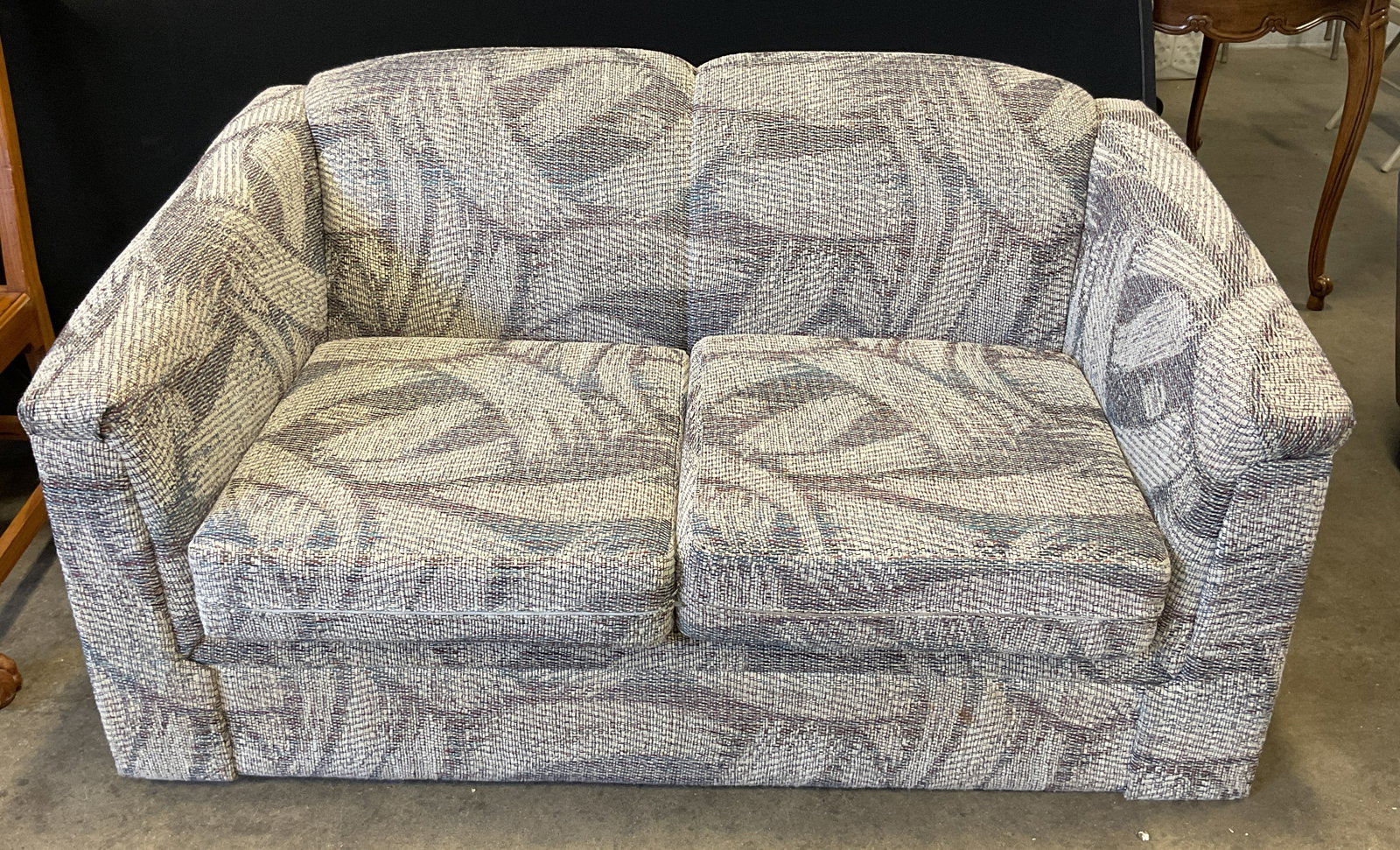 White Multi Tweed Upholstered Loveseat Sofa: White multicolor tweed style upholstered loveseat sofa with abstract pattern. Measures approx. 57 x 34 x 30 inches. Some wear consistent with exposure. Some blemishes, Tweed sofa, tweed loveseat, whit